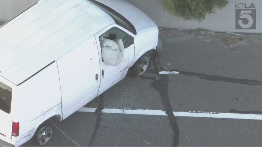 The suspect stuffed a large blanket into the shattered van window to block officers' non-lethal rounds. (KTLA)