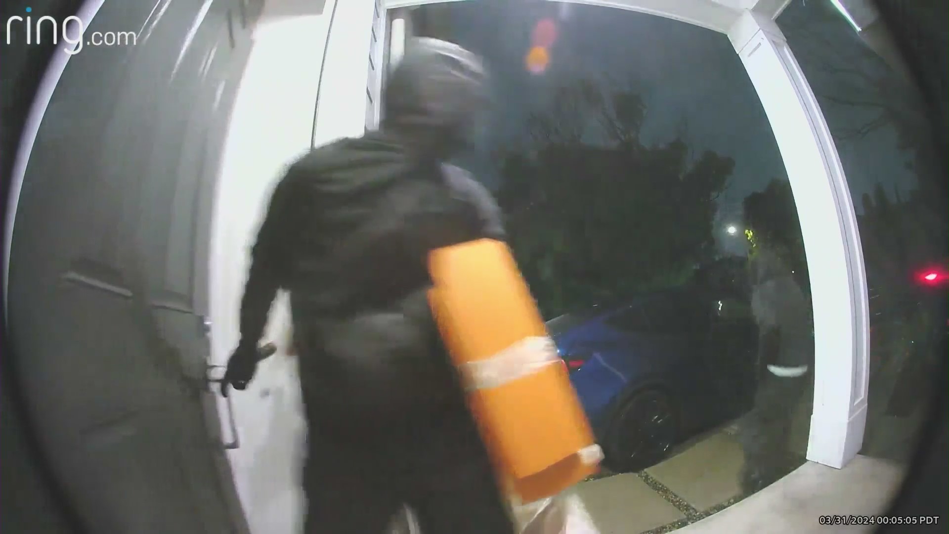 Burglars running out the front door after stealing items from a Westchester home.