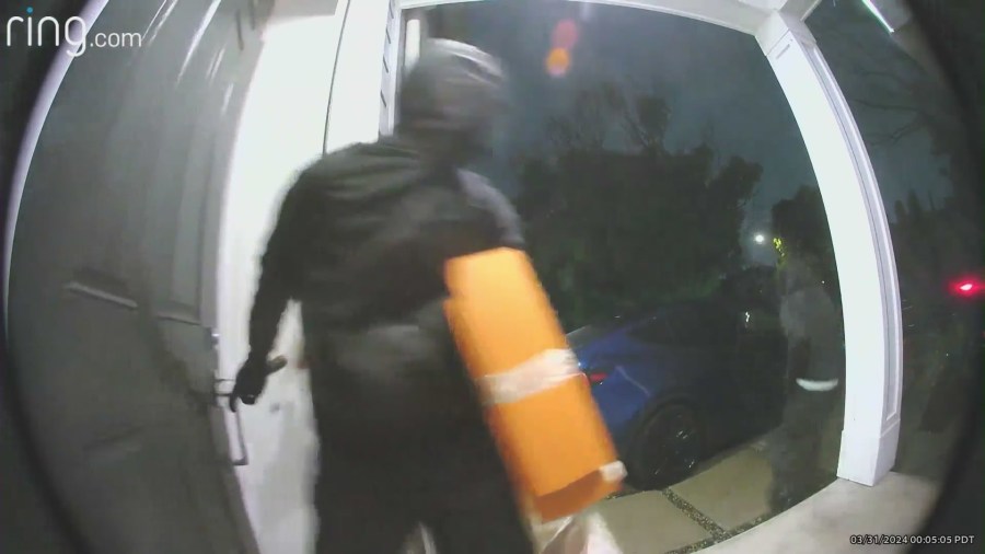 Burglars running out the front door after stealing items from a Westchester home. 