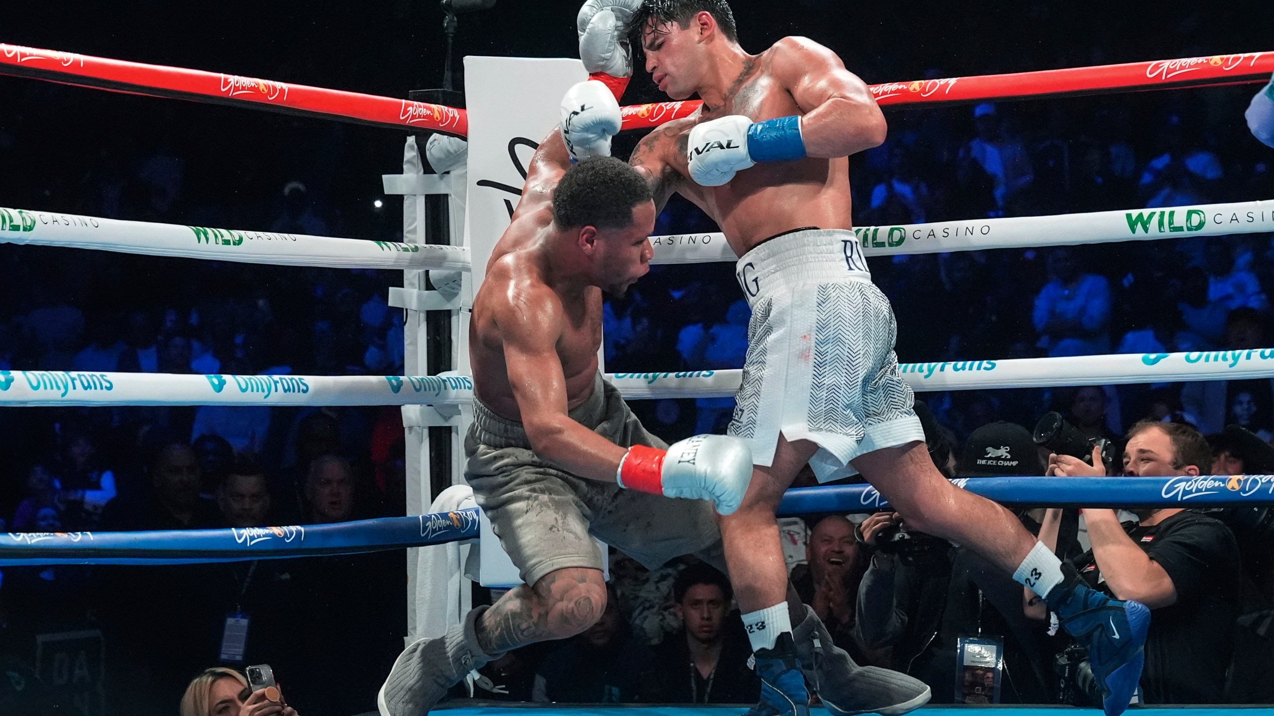 Ryan Garcia, right, knocks down Devin Haney during the 10th round of a super lightweight boxing match early Sunday, April 21, 2024, in New York. Garcia won the fight. (AP Photo/Frank Franklin II)