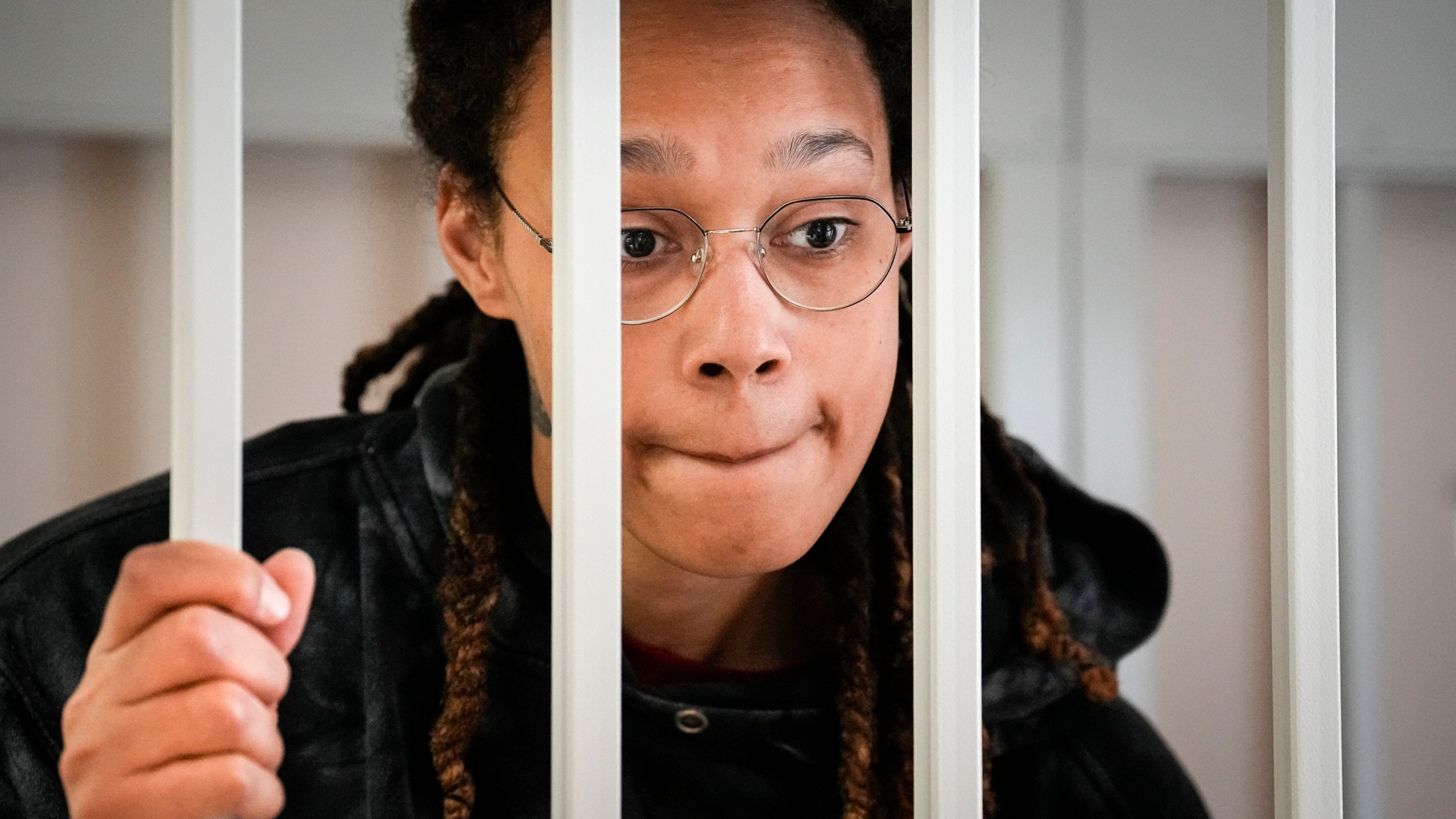 FILE - WNBA star and two-time Olympic gold medalist Brittney Griner speaks to her lawyers from inside a cage in a courtroom in Khimki, outside Moscow, Russia, on July 26, 2022. Griner continues her efforts to settle into a normal routine following her release from a Russian prison 17 months ago. (AP Photo/Alexander Zemlianichenko, Pool, File)