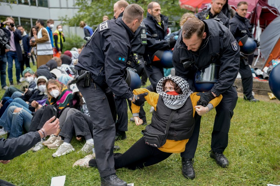 A woman is carried away by police officers during a pro-Palestinians demonstration by the group "Student Coalition Berlin" in the theater courtyard of the 'Freie Universität Berlin' university in Berlin, Germany, Tuesday, May 7, 2024. Pro-Palestinian activists occupied a courtyard of the Free University in Berlin on Tuesday. (AP Photo/Markus Schreiber)