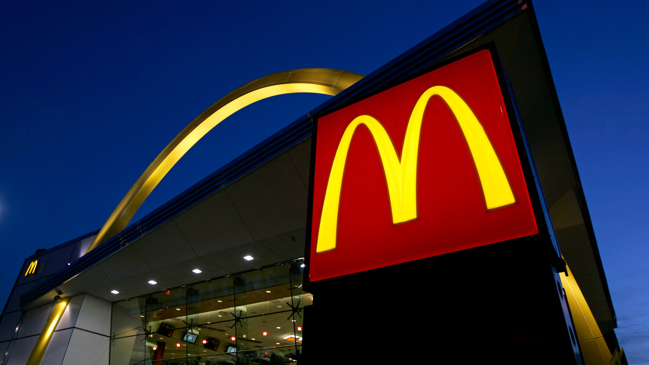 FILE - The McDonald's restaurant logo and golden arch is lit up, April 20, 2006, in Chicago. McDonald’s plans to introduce a $5 meal deal in the U.S. in June 2024 to counter slowing sales and customers’ frustration with high prices. (AP Photo/Jeff Roberson, File)