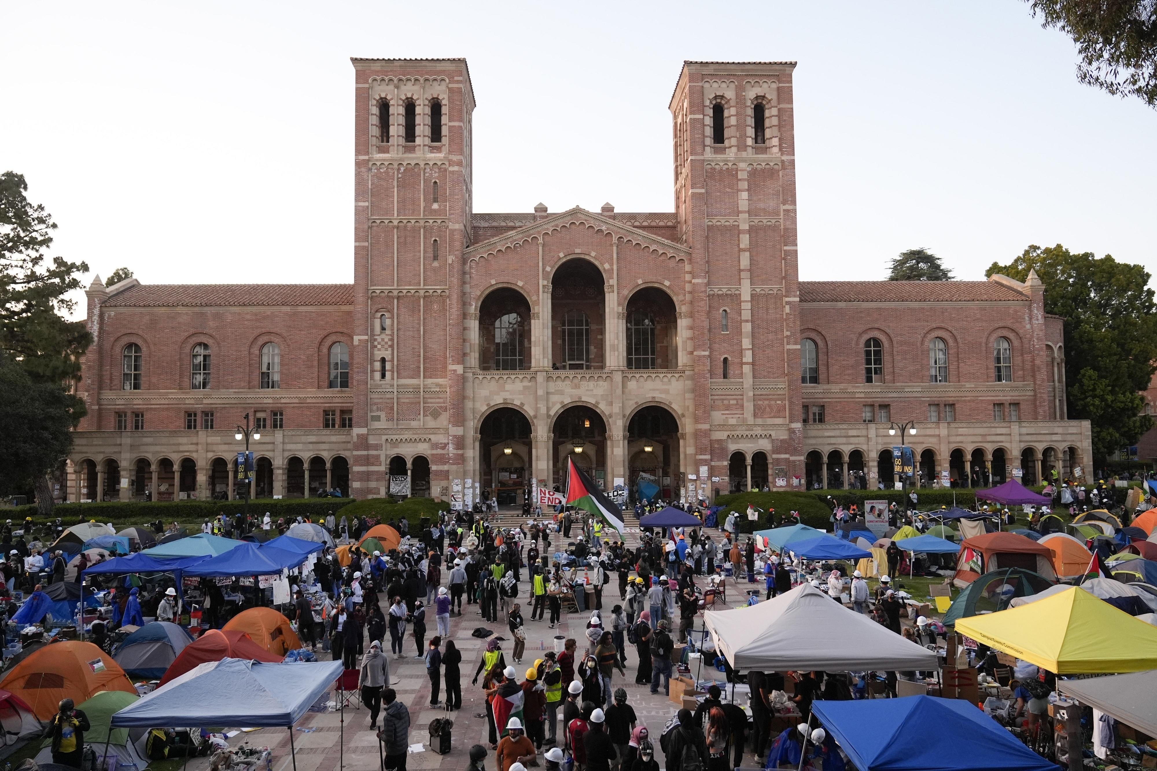 FILE - Demonstrators walk in an encampment on the UCLA campus after clashes between pro-Israel and pro-Palestinian groups, Wednesday, May 1, 2024, in Los Angeles. Leaders from Northwestern University, the University of California, Los Angeles, and Rutgers University are expected to testify before Congress on Thursday, the latest in a series of hearings spearheaded by House Republicans into how colleges have responded to pro-Palestinian protests on their campuses. (AP Photo/Jae C. Hong, file)