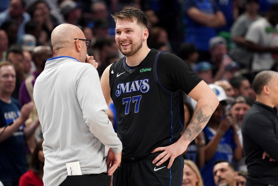 Dallas Mavericks guard Luka Doncic (77) talk with head coach Jason Kidd, left, during the first half of Game 6 of an NBA basketball first-round playoff series against the Los Angeles Clippers, Friday, May 3, 2024, in Dallas. (AP Photo/Jeffrey McWhorter)