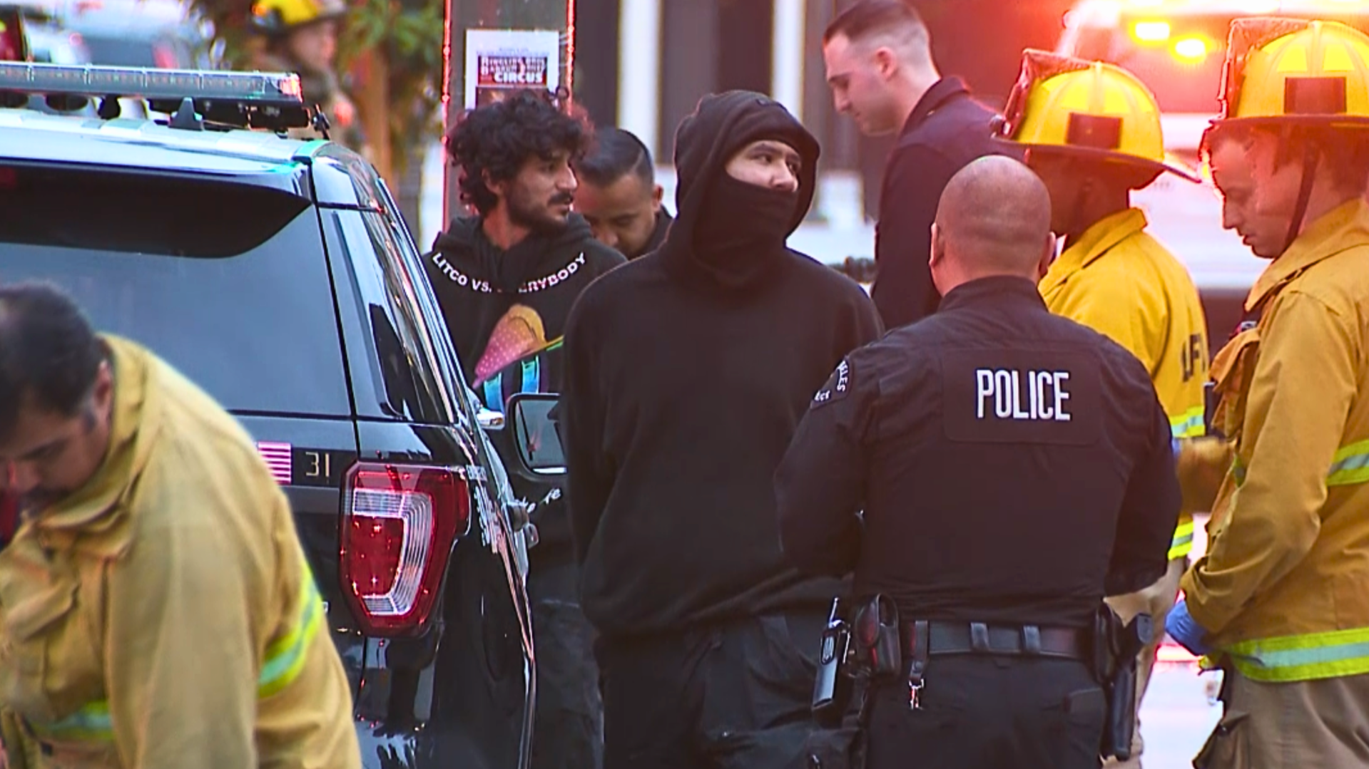 Two men are seen being taken into custody outside a Metro station in downtown Los Angeles on May 16, 2024.