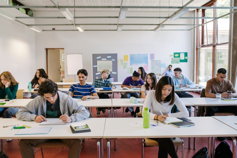 A group of high school students at their desks working hard during a class. (Getty Images)