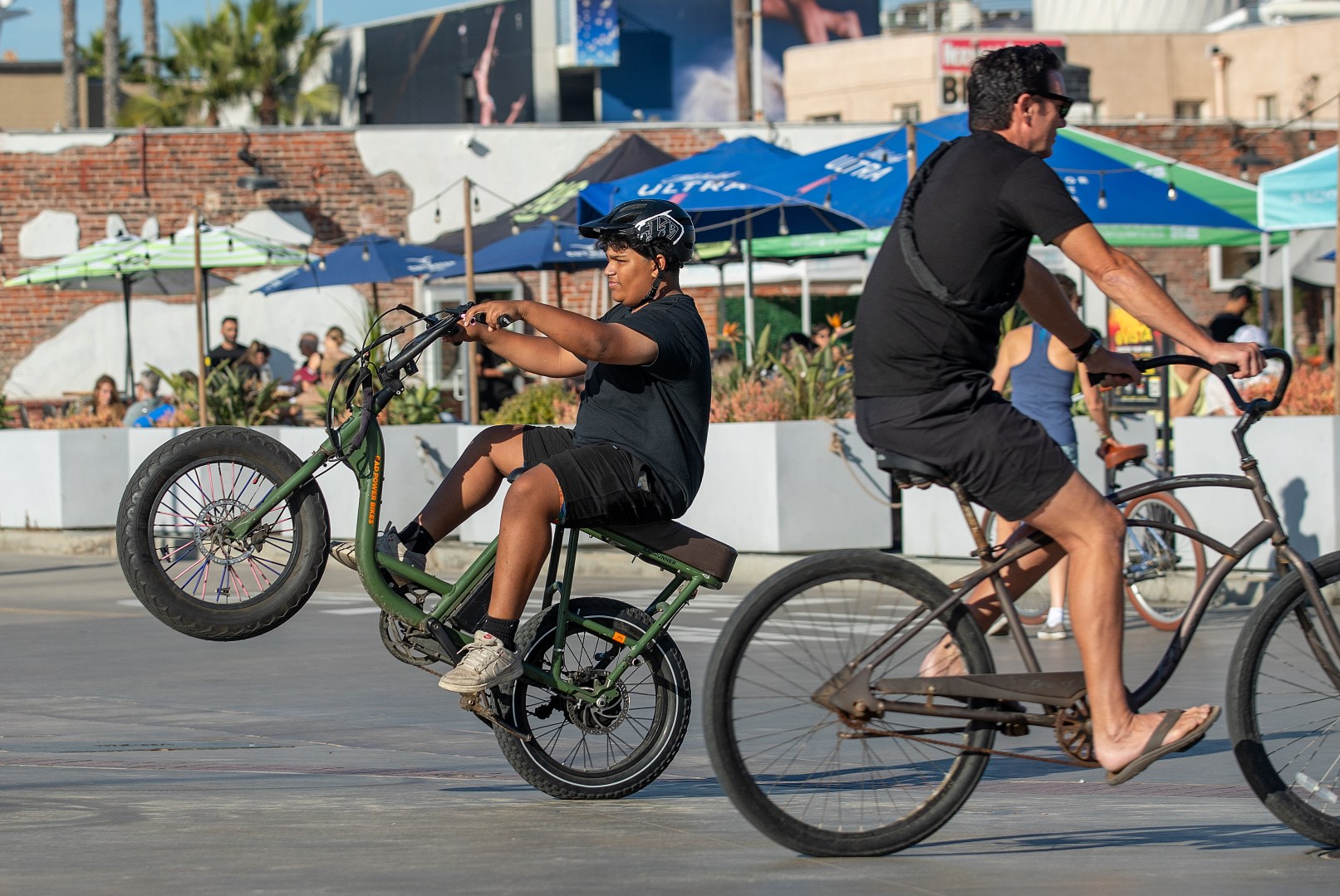 HERMOSA BEACH, CA-NOVEMBER 10, 2023, 2023:A boy rides his e-bike on the Strand in Hermosa Beach. In Hermosa Beach, it's against city code to use electric power on the Strand, but many e-bike riders do so anyway. (Mel Melcon / Los Angeles Times via Getty Images)