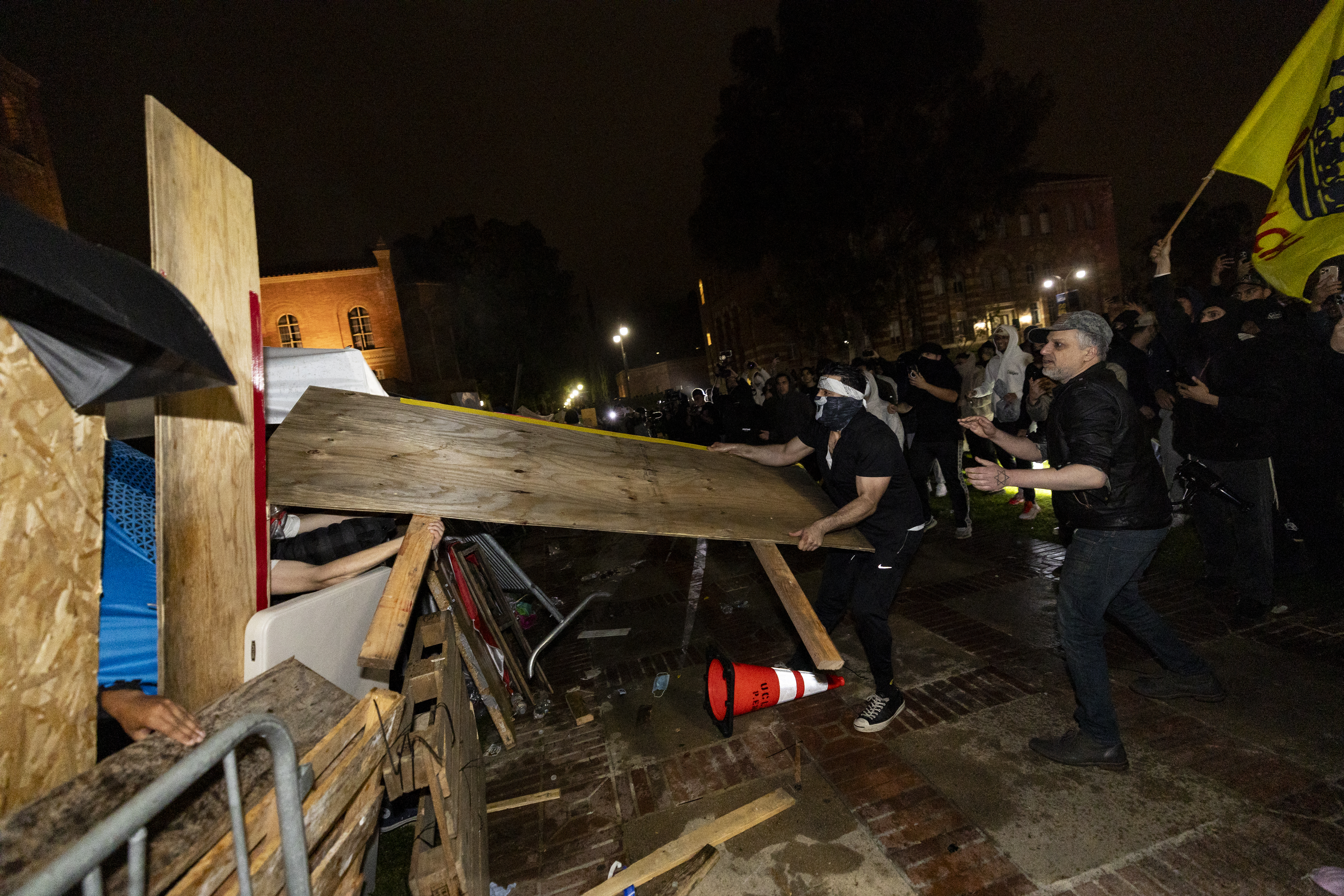 Counter protesters attack a pro-Palestinian encampment set up on the campus of the University of California Los Angeles (UCLA) as clashes erupt, in Los Angeles on May 1, 2024.