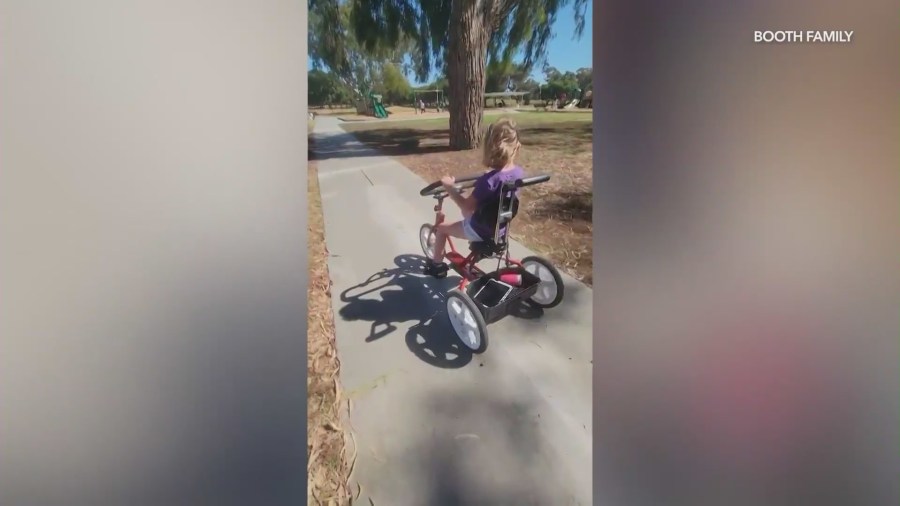 Alli Booth, 7, is seen riding her custom adaptive tricycle. (Booth Family)