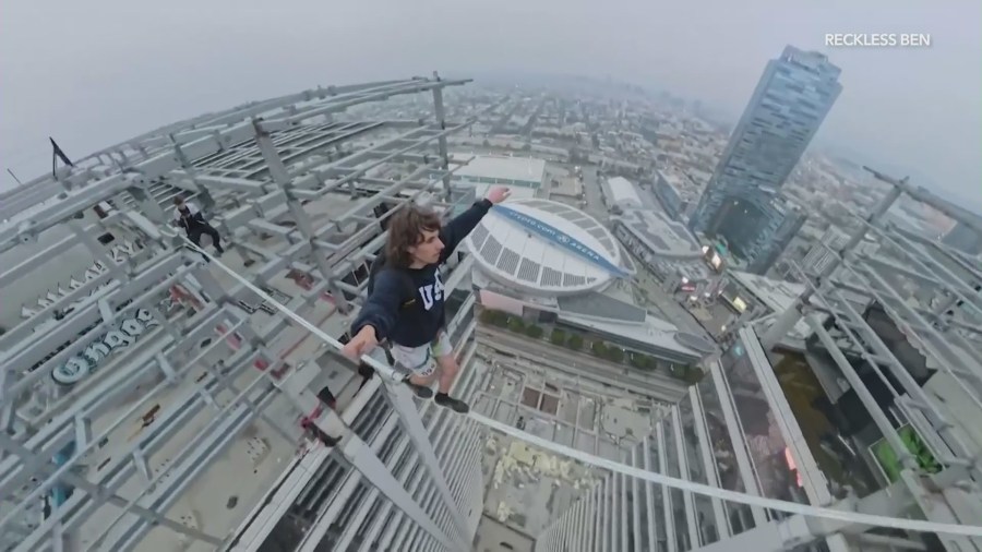 YouTube daredevil and performance artist Ben Schneider is seen walking a small rope tied between two skyscrapers in downtown Los Angeles on May 12, 2024. (Ben Schneider)