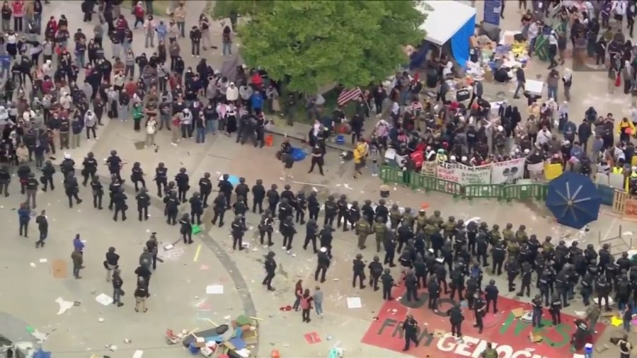 Law enforcement officers are seen approaching a protest encampment at UC Irvine on May 15, 2024. (KTLA)