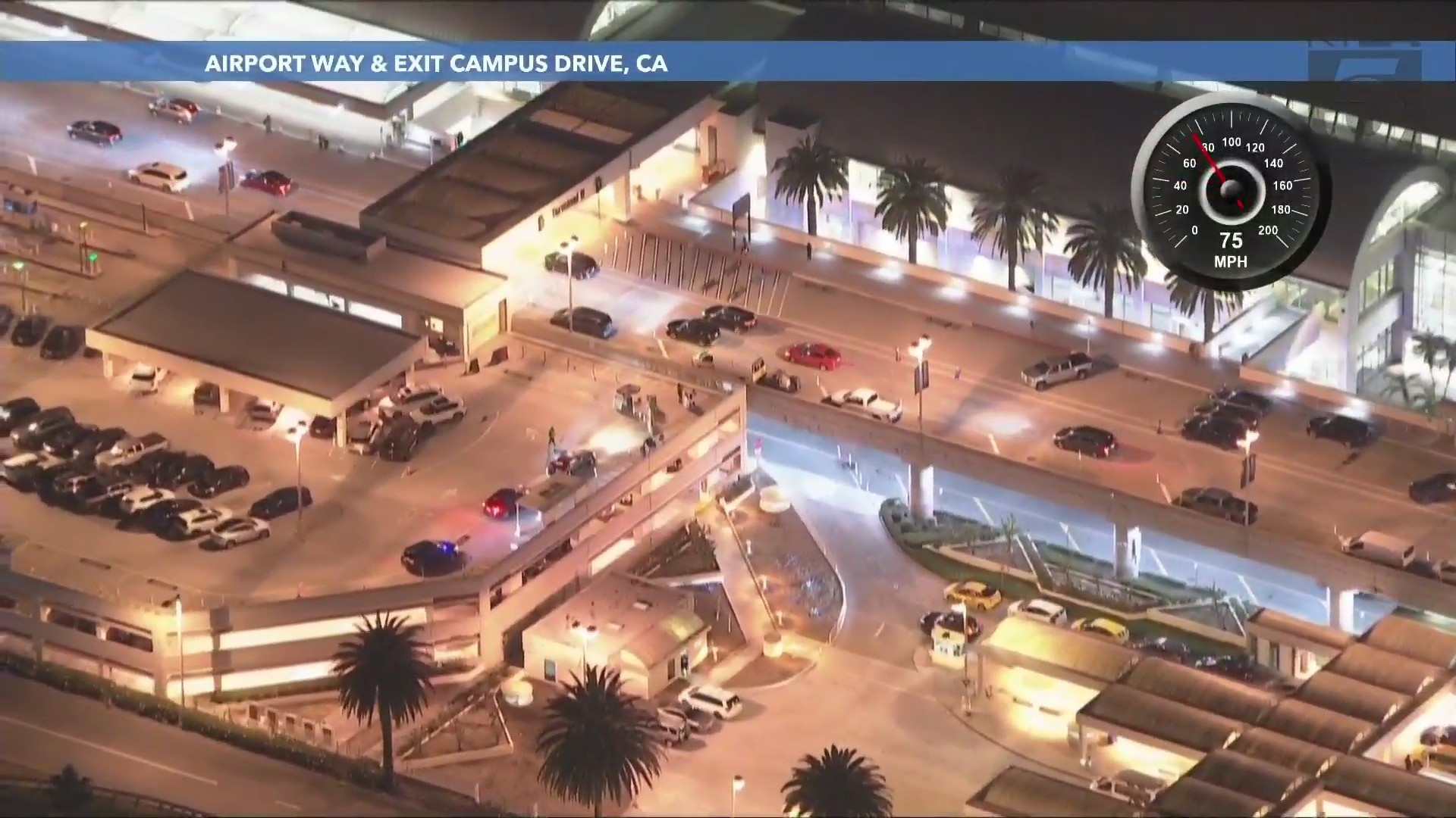 The driver enters the John Wayne Airport in Santa Ana as an officer follows closely behind on May 24, 2024. (KTLA)