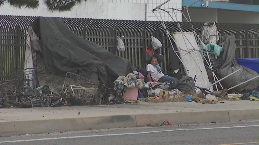 A homeless encampemnt surrounding the gate of Pioneer Memorial Cemetery in San Bernardino, California. (KTLA)