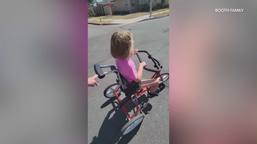 Alli Booth, 7, is seen riding her custom adaptive tricycle. (Booth Family)