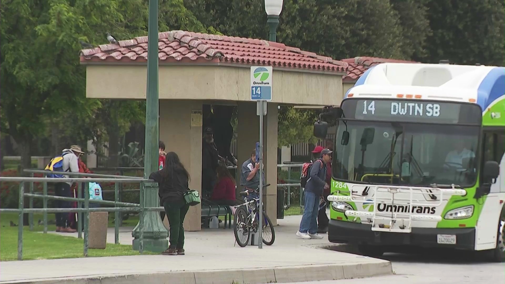 Riders waiting to board a Metro bus in Fontana, California. (KTLA)