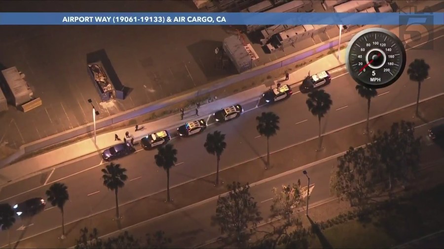 Officers investigated the suspects' blue sedan on a side street after multiple passengers were arrested at John Wayne Airport in Santa Ana on May 24, 2024. (KTLA)