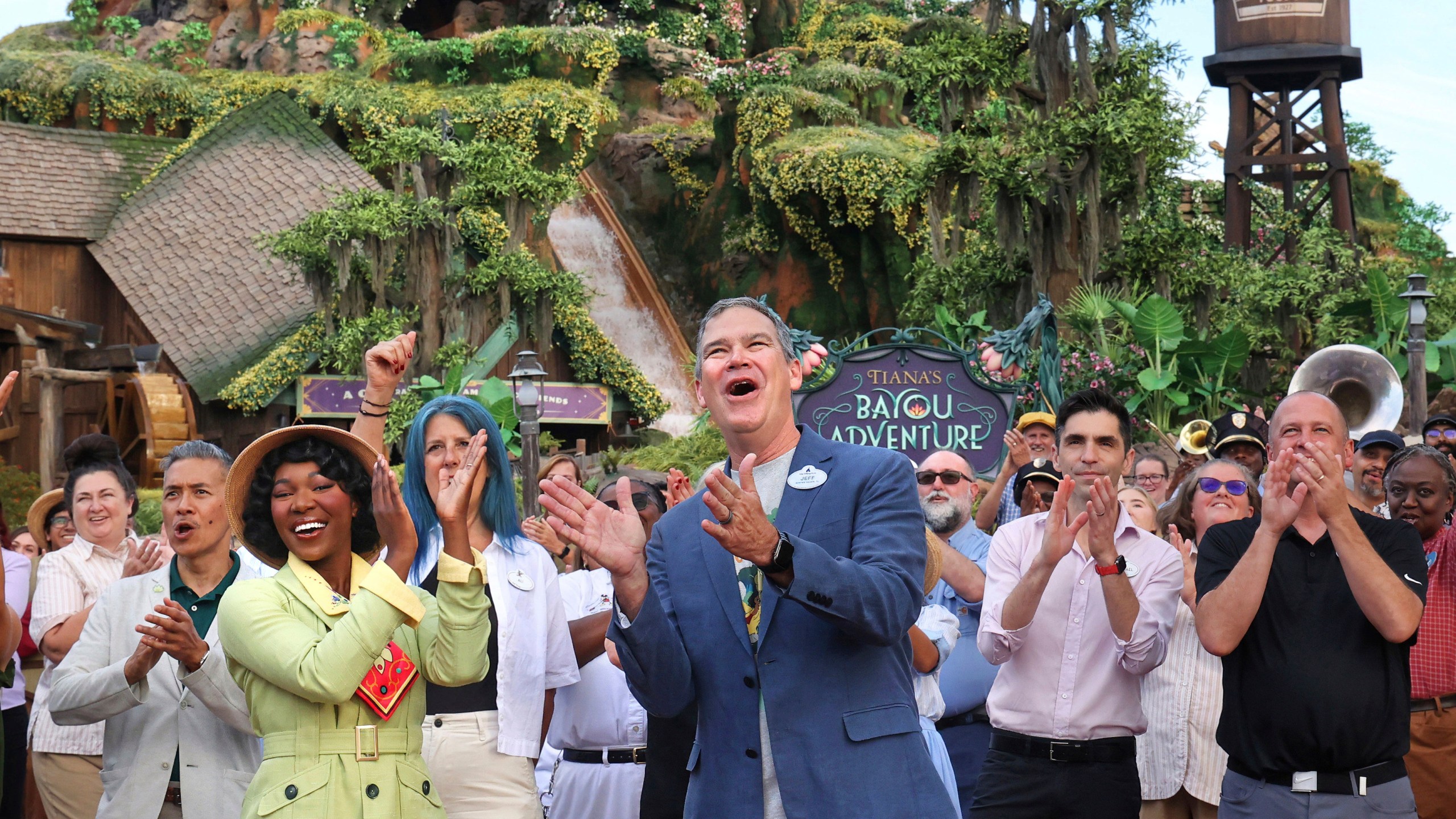 With Princess Tiana, Walt Disney World president Jeff Vahle cheers employees during a "Thank You Fête" honoring cast members at a preview event for Tiana's Bayou Adventure at the Magic Kingdom in Bay Lake, Fla., Monday, June 10, 2024. The ride —redeveloped from the park's original Splash Mountain— officially opens to Disney guests on June 28. (Joe Burbank/Orlando Sentinel via AP)