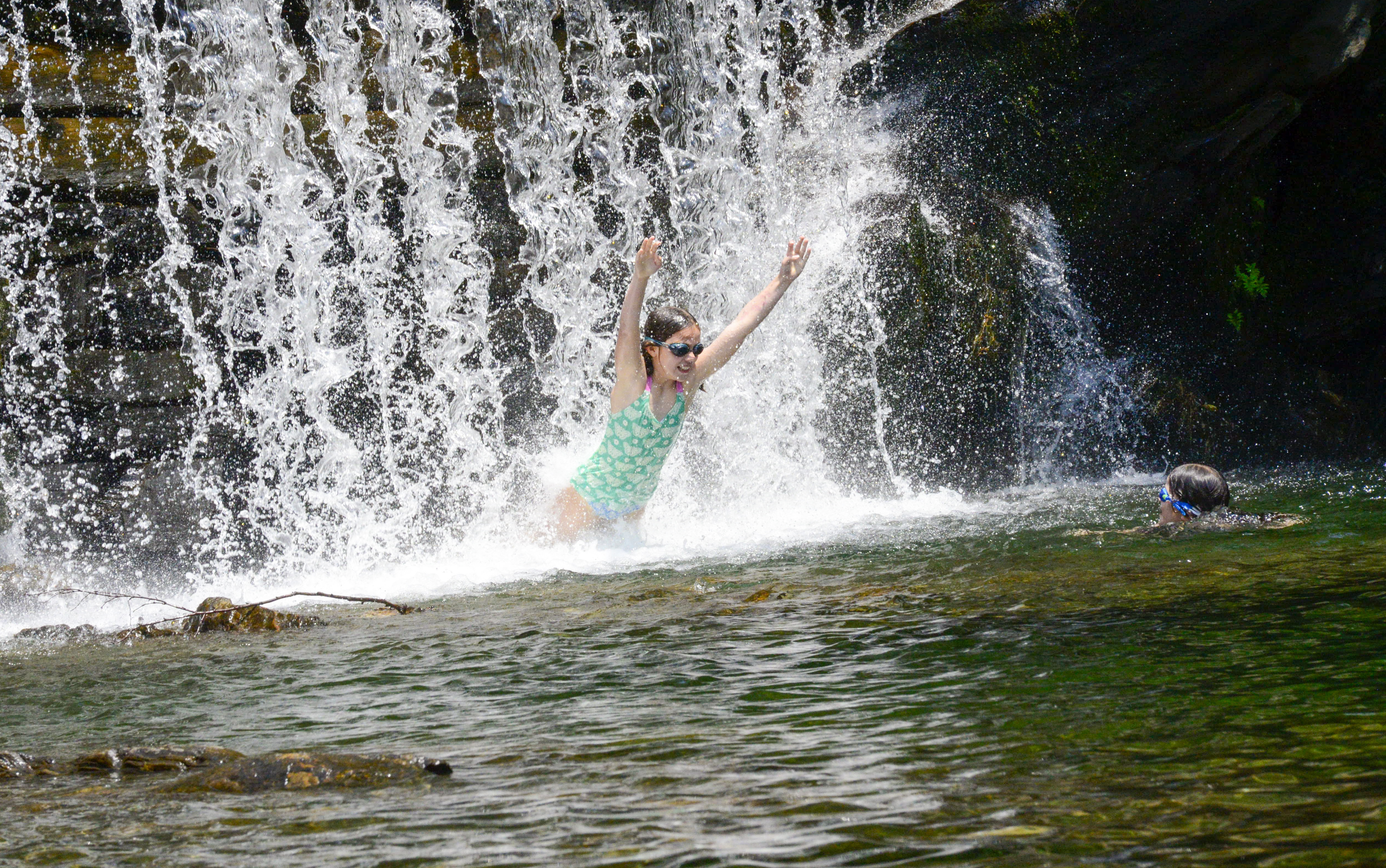 Finoa Murdie, 10, jumps through the water at the Green River Timber Crib Dam in Guilford, Vt., on Wednesday, June 19, 2024. (Kristopher Radder /The Brattleboro Reformer via AP)