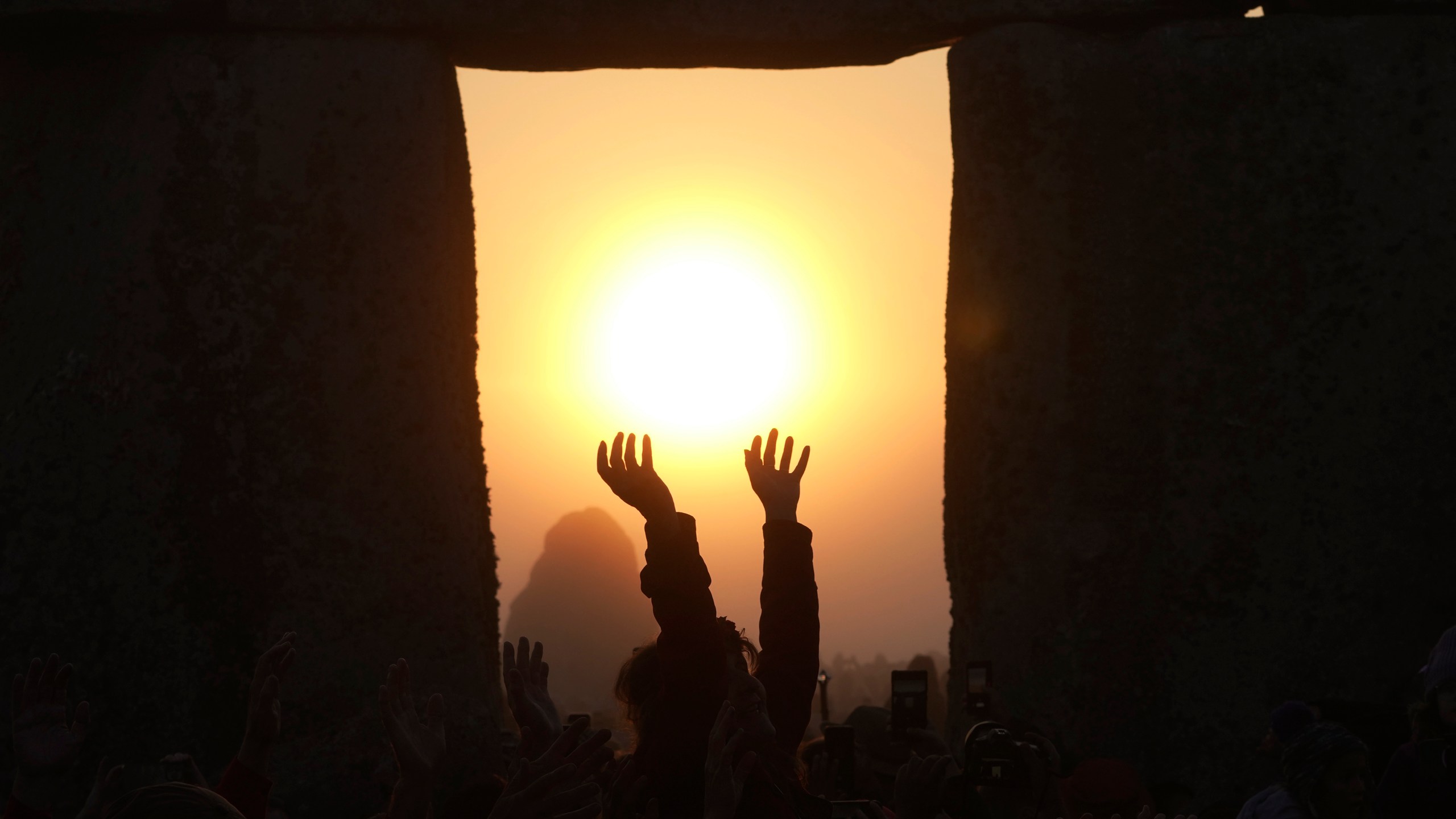 FILE - Revelers gather at the ancient stone circle Stonehenge to celebrate the summer solstice, the longest day of the year, near Salisbury, England, June 21, 2023. Summer kicks off in the Northern Hemisphere once again with the summer solstice on Thursday, June 20, 2024. (AP Photo/Kin Cheung, File)