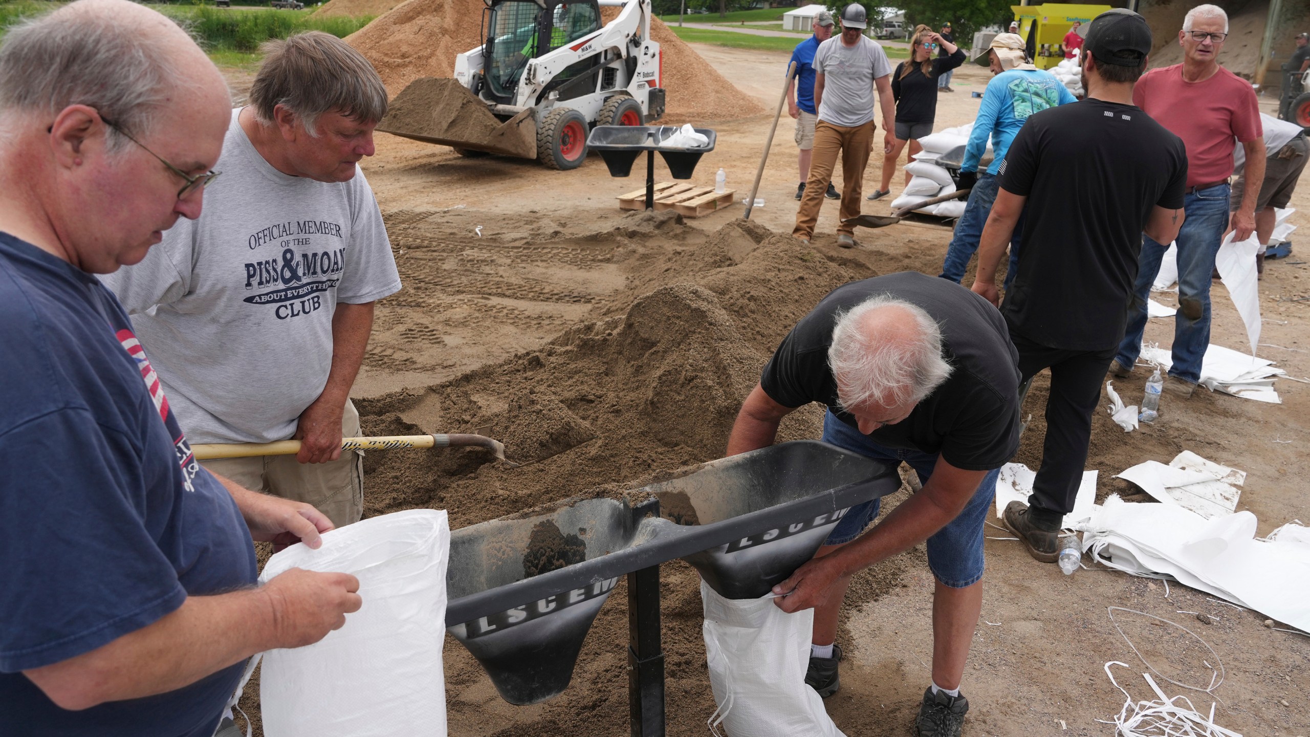 Volunteers help fill sandbags as heavy rains have caused both Tetonka Lake and Sakatah Lake to rise threatening to flood nearby homes and businesses Thursday, June 20, 2024 in Waterville, Minn. (Anthony Souffle/Star Tribune via AP)