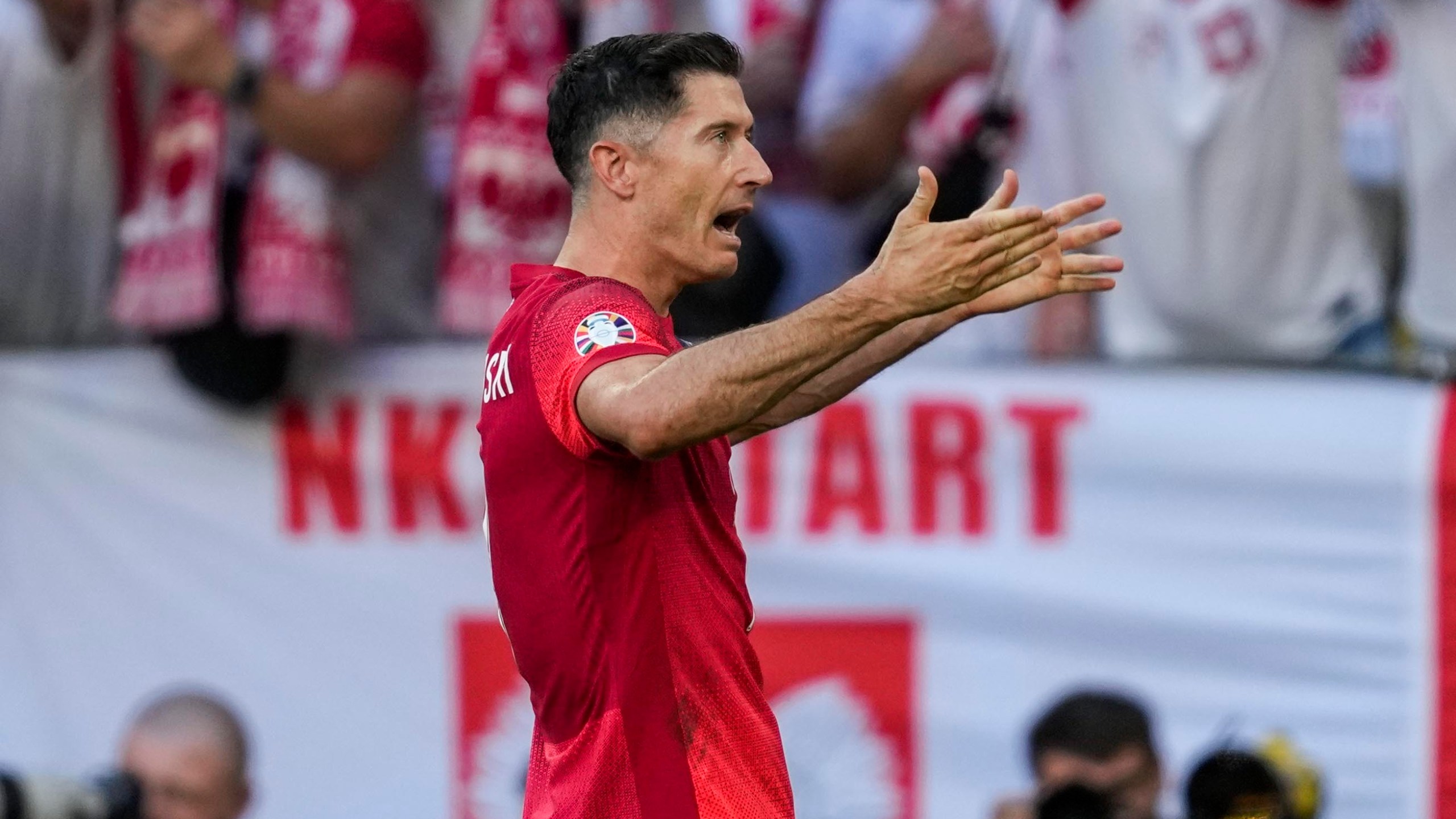 Poland's Robert Lewandowski celebrates after scoring a penalty kick during a Group D match between the France and Poland at the Euro 2024 soccer tournament in Dortmund, Germany, Tuesday, June 25, 2024. (AP Photo/Darko Vojinovic)