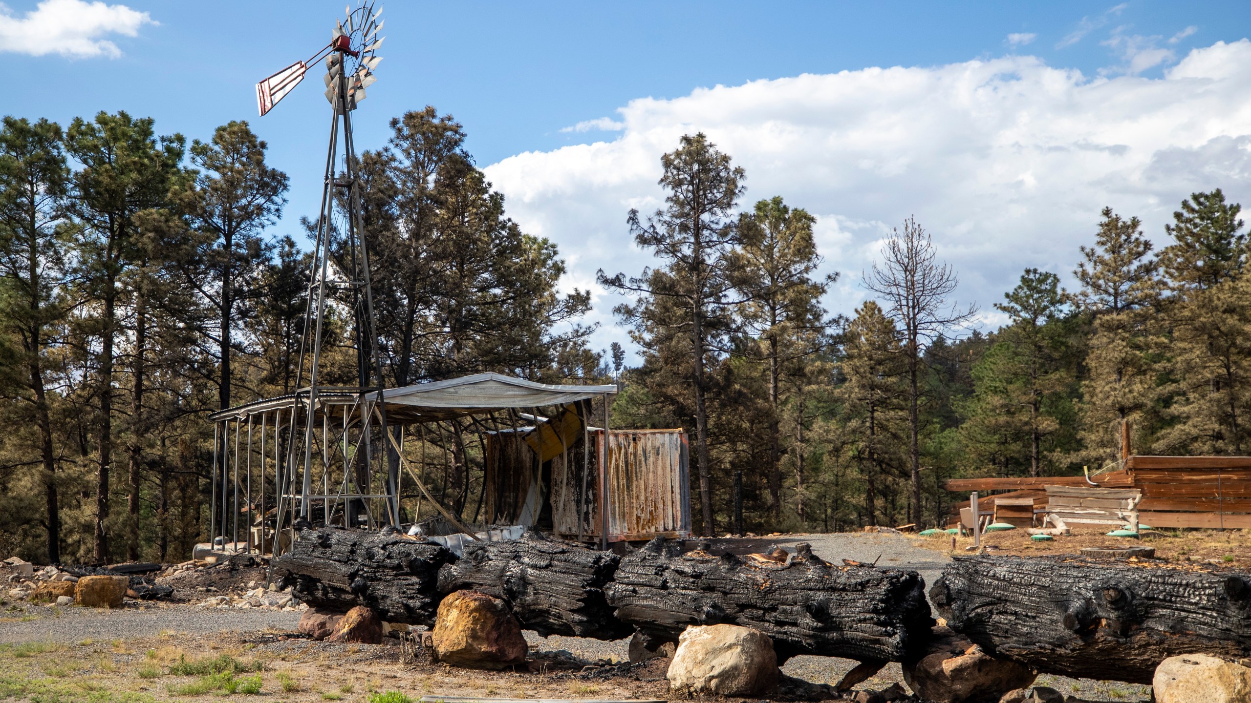 The remains of a business destroyed by the South Fork Fire are pictured in the mountain village of Ruidoso, N.M., Saturday, June 22, 2024. (AP Photo/Andres Leighton)