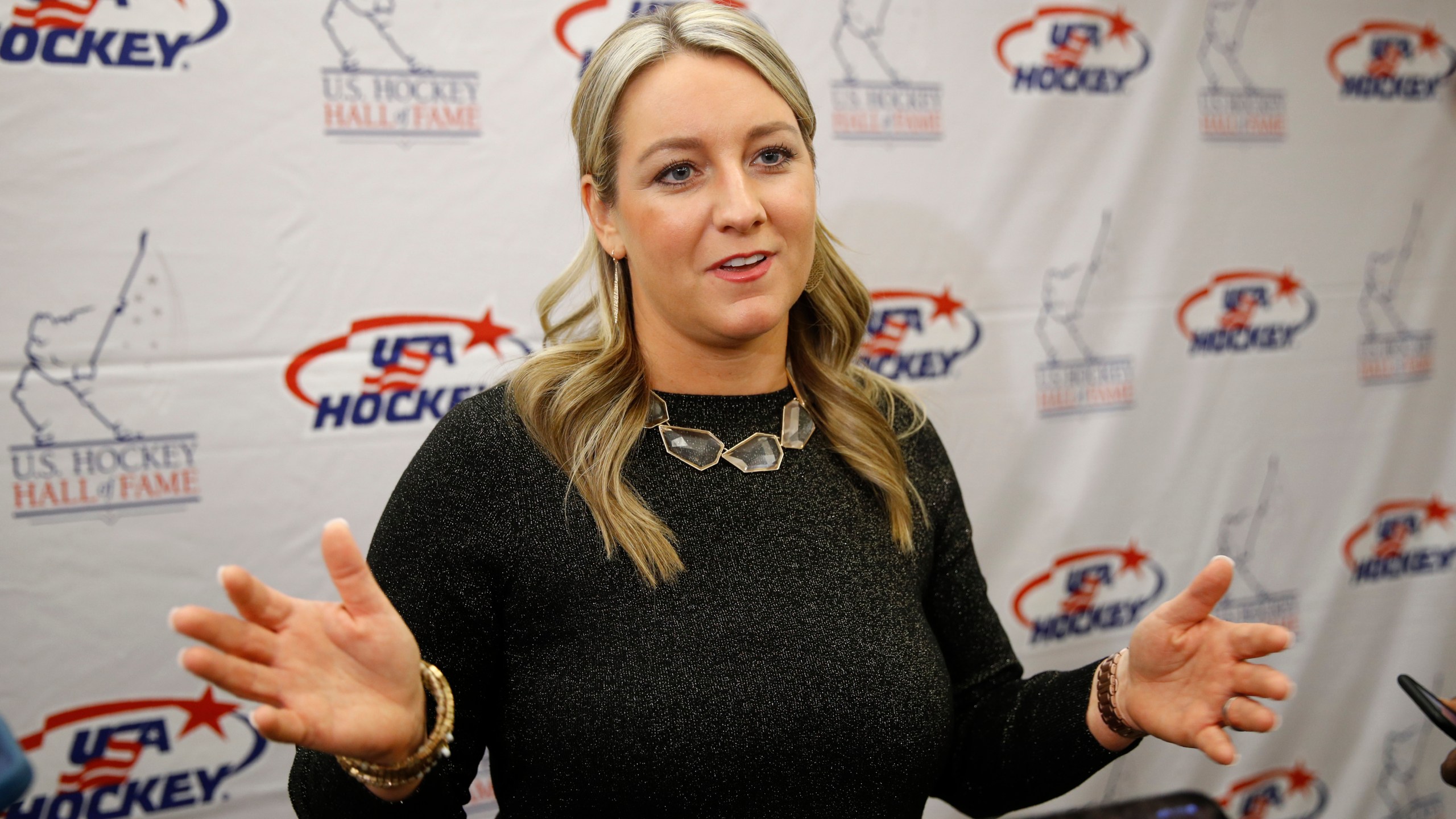 FILE - Olympic medalist Krissy Wendell speaks with members of the media before being inducted into the U.S. Hockey Hall of Fame, Thursday, Dec. 12, 2019, in Washington. Wendell is part of the Hall of Fame class of 2024. (AP Photo/Patrick Semansky, File)