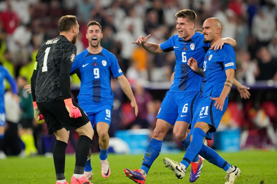 Slovenia's players celebrate at the end of a Group C match between the England and Slovenia at the Euro 2024 soccer tournament in Cologne, Germany, Tuesday, June 25, 2024. (AP Photo/Andreea Alexandru)