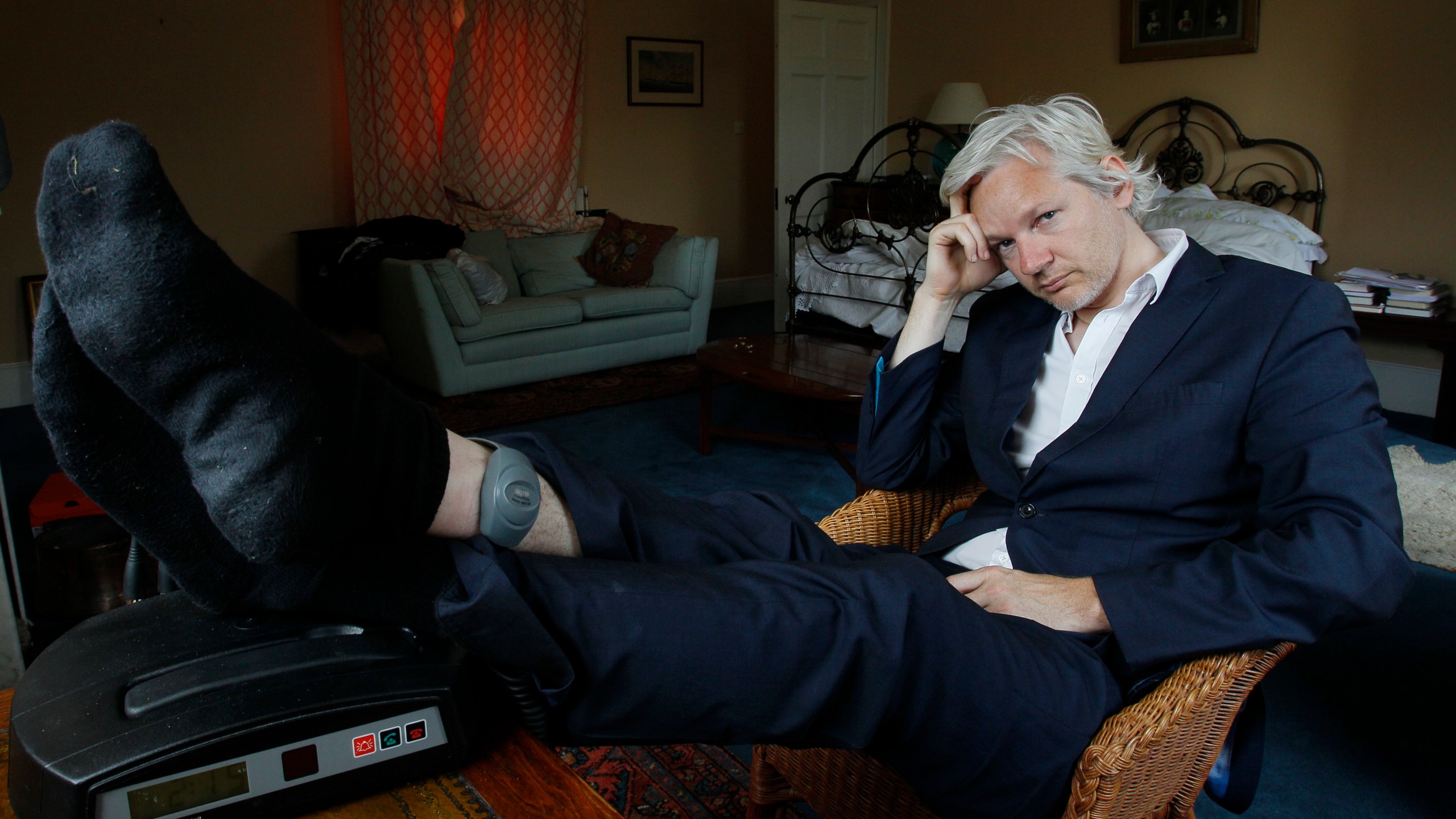 FILE - WikiLeaks founder Julian Assange is seen with his ankle security tag at the house where he is required to stay, near Bungay, England, Wednesday, June 15, 2011. Assange will plead guilty to a felony charge in a deal with the U.S. Justice Department that will free him from prison and resolve a long-running legal saga over the publication of a trove of classified documents. (AP Photo/Kirsty Wigglesworth, File)