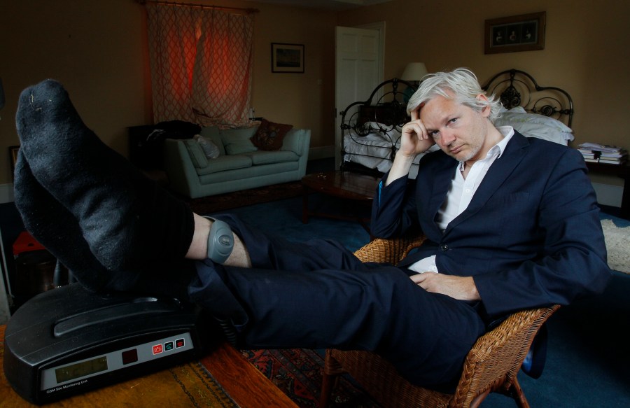FILE - WikiLeaks founder Julian Assange is seen with his ankle security tag at the house where he is required to stay, near Bungay, England, Wednesday, June 15, 2011. Assange will plead guilty to a felony charge in a deal with the U.S. Justice Department that will free him from prison and resolve a long-running legal saga over the publication of a trove of classified documents. (AP Photo/Kirsty Wigglesworth, File)