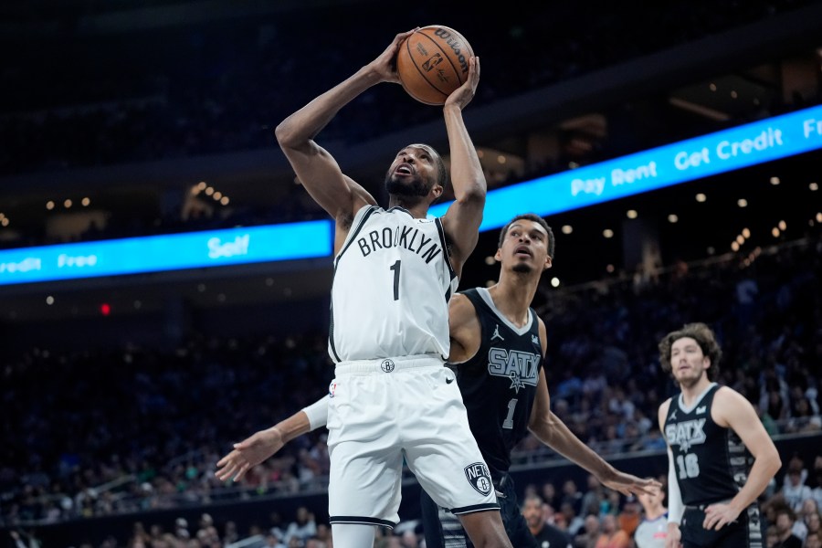 FILE - Brooklyn Nets forward Mikal Bridges, left, scores past San Antonio Spurs center Victor Wembanyama, center, during the first half of an NBA basketball game in Austin, Texas, March 17, 2024. Bridges is being traded from the Nets to the New York Knicks, where he will join Jalen Brunson and other former Villanova teammates, a person with knowledge of the details said Tuesday, June 25. (AP Photo/Eric Gay, File)