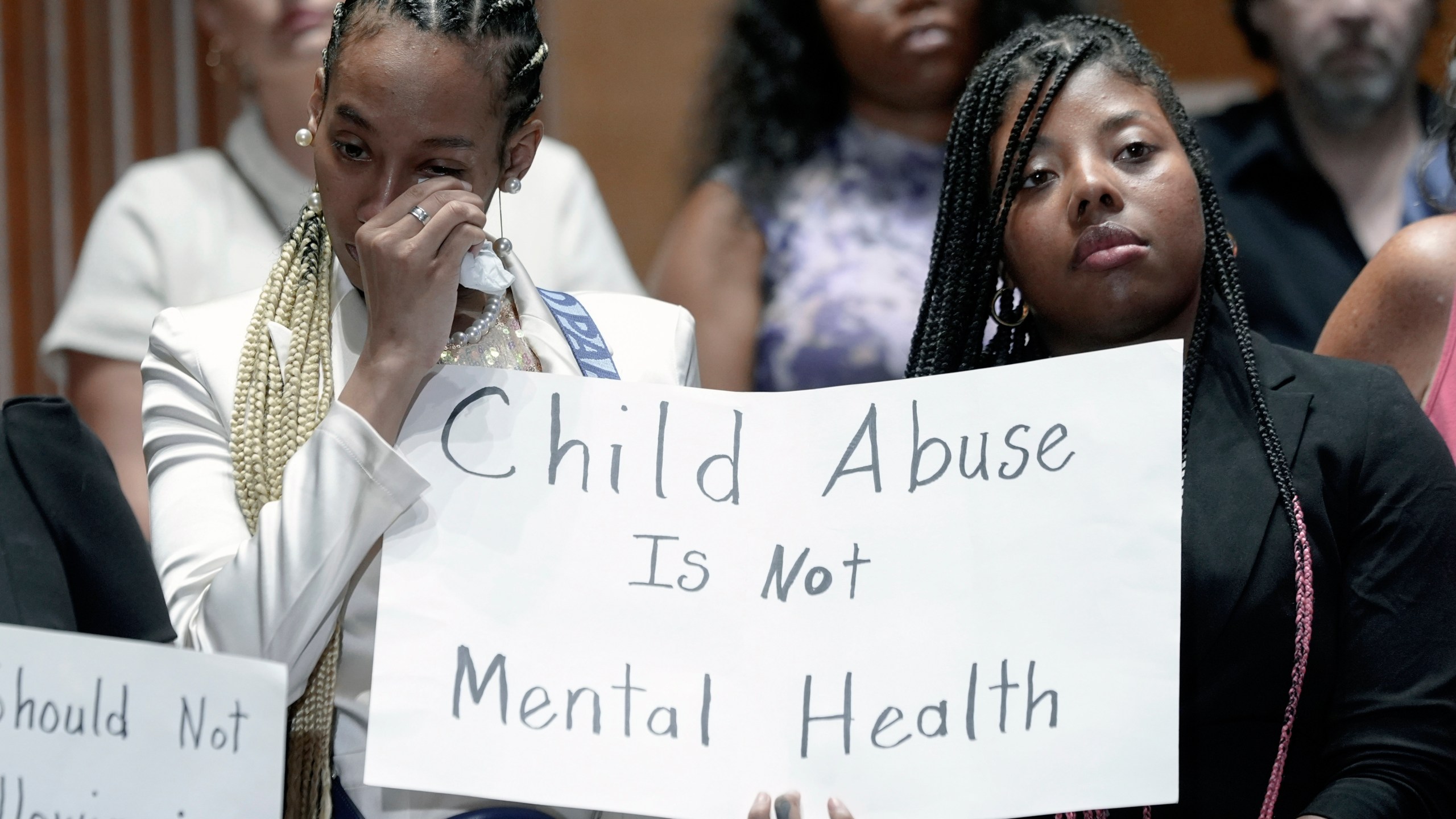 Victims are emotional during a news conference with survivors of abused and neglected youth at residential treatment facilities (RTFs) and advocates, on the need for Congress to act to protect children and reform RTFs, Wednesday, June 12, 2024, on Capitol Hill in Washington. (AP Photo/Mariam Zuhaib)