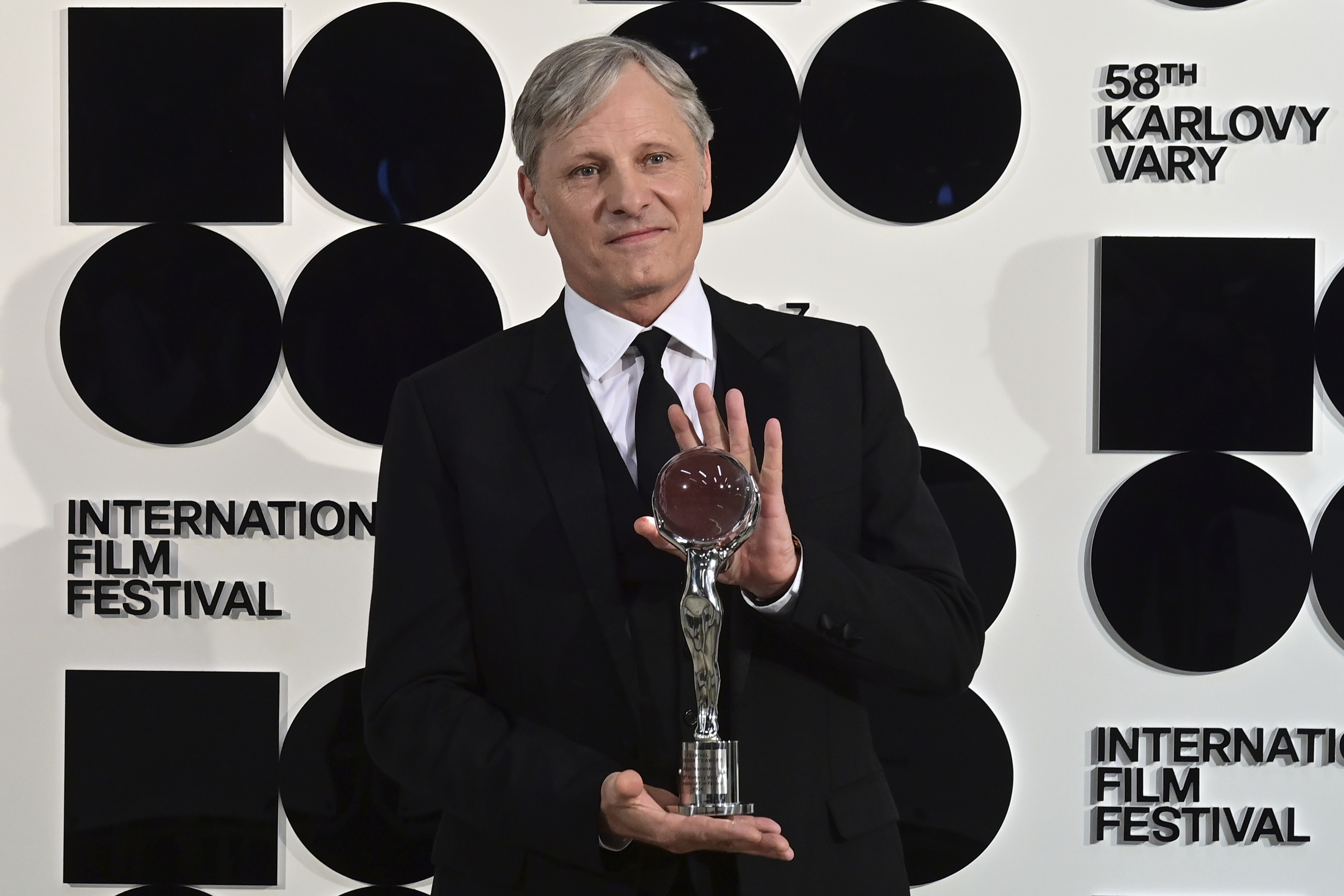 U.S. actor and director Viggo Mortensen poses with the Golden Globe award received during the opening ceremony of the 58th Karlovy Vary International Film Festival in Karlovy Vary, Czech Republic, Friday, June 28, 2024. An international film festival in the western Czech spa of Karlovy Vary has kicked off with an honor for U.S. actor and director Viggo Mortensen. Mortensen, who was nominated three times for the Academy Award as the best actor, received the Festival President’s Award at Friday’s opening ceremony and present the second movie he directed “The Dead Don’t Hurt.” (Slavomir Kubes/CTK via AP)