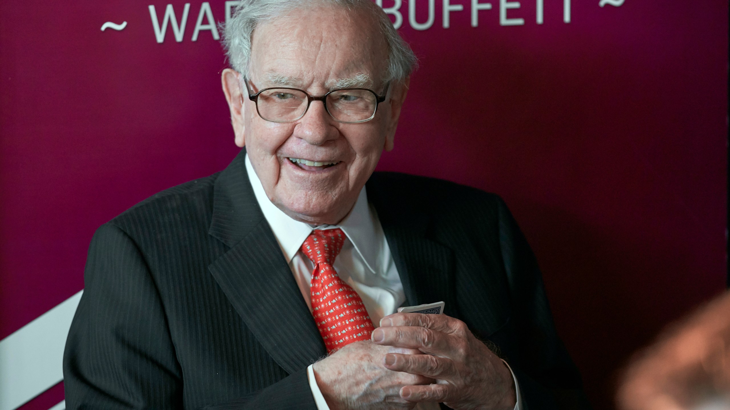 FILE - Warren Buffett, chairman and CEO of Berkshire Hathaway, smiles as he plays bridge following the annual Berkshire Hathaway shareholders meeting in Omaha, Neb., May 5, 2019. Buffett is giving away another $5.3 billion worth of Berkshire Hathaway stock to five foundations in accordance with his longtime giving plan. (AP Photo/Nati Harnik, File)