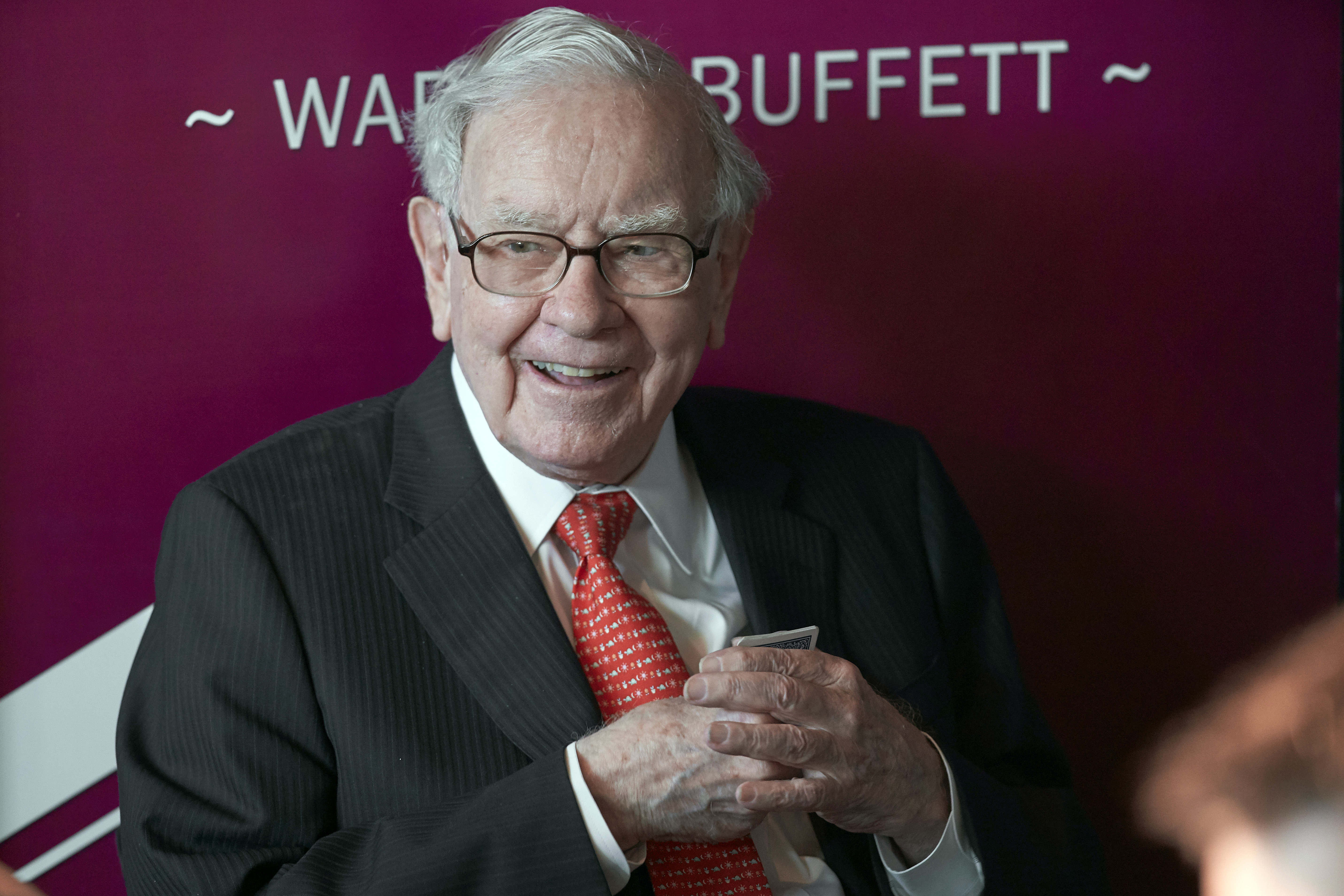 FILE - Warren Buffett, chairman and CEO of Berkshire Hathaway, smiles as he plays bridge following the annual Berkshire Hathaway shareholders meeting in Omaha, Neb., May 5, 2019. Buffett is giving away another $5.3 billion worth of Berkshire Hathaway stock to five foundations in accordance with his longtime giving plan. (AP Photo/Nati Harnik, File)