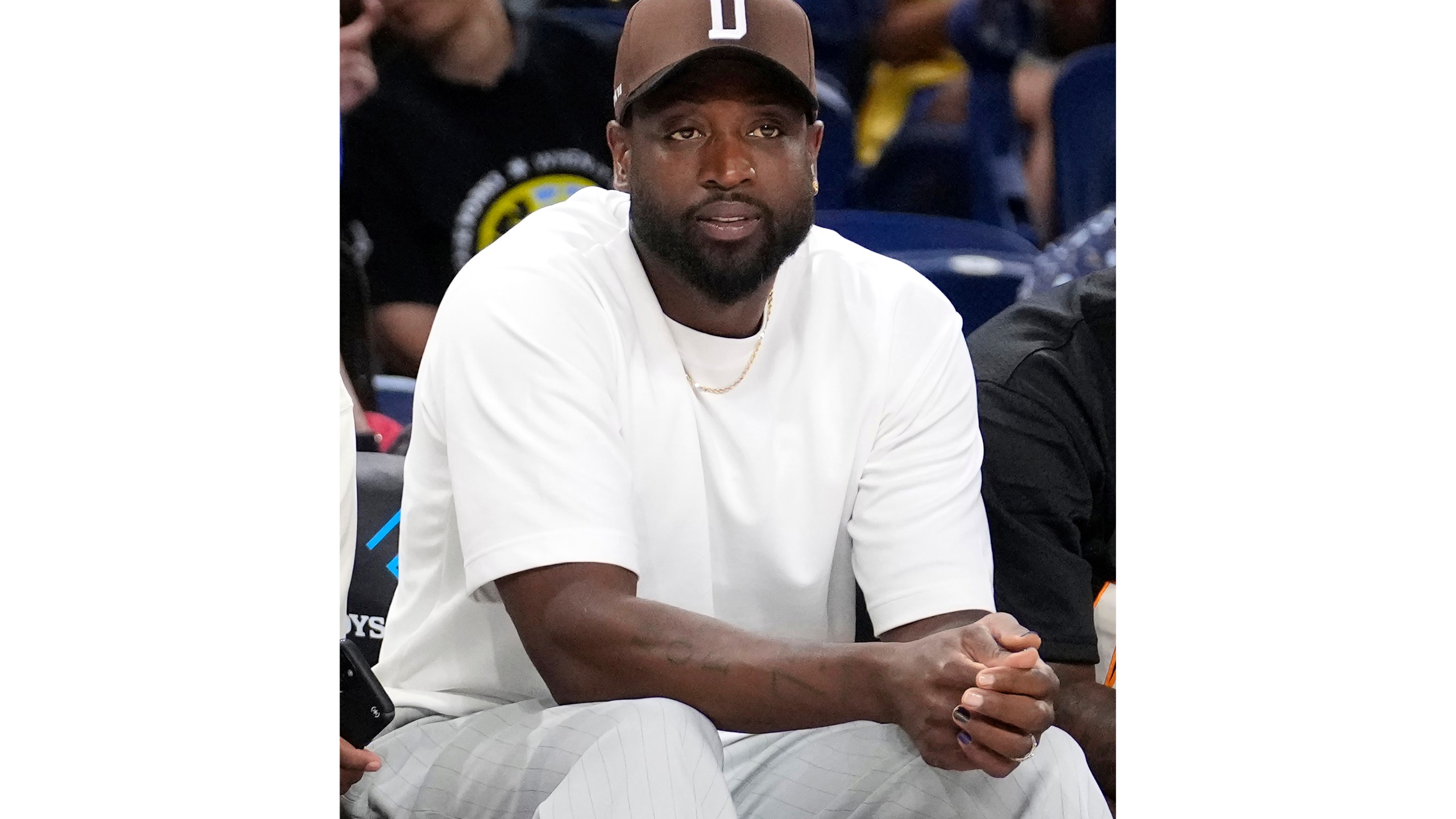 FILE - Dwyane Wade sits courtside before a game between the Sky and the Connecticut Sun, Wednesday, June 12, 2024, in Chicago. Dwyane Wade became a partial owner of the Chicago Sky last year. (AP Photo/Charles Rex Arbogast, File)