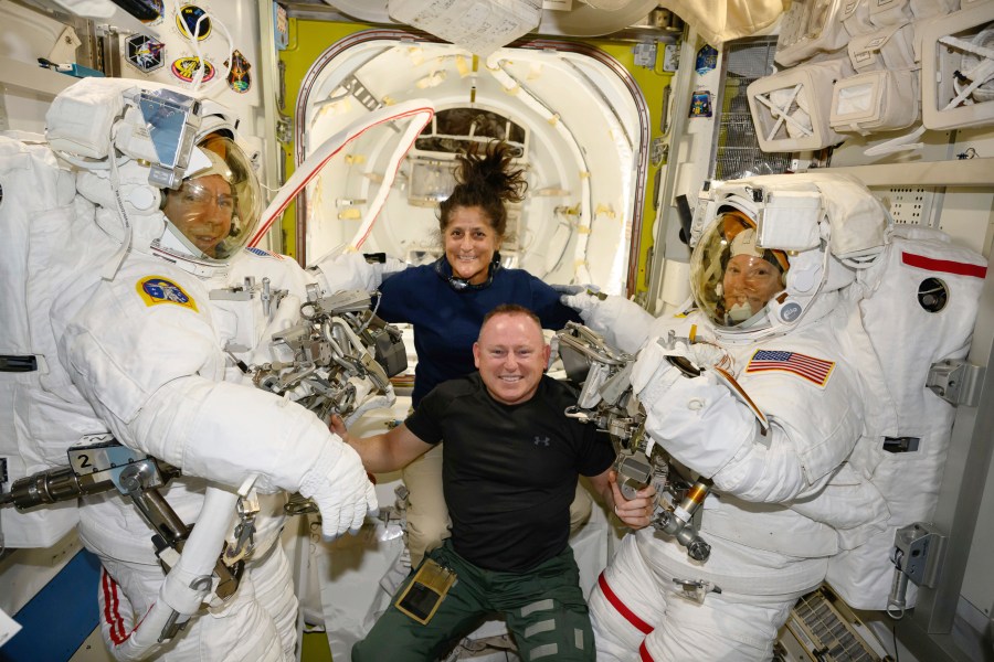 In this photo provided by NASA, Boeing Crew Flight Test astronauts Suni Williams and Butch Wilmore, center, pose with Expedition 71 Flight Engineers Mike Barratt, left, and Tracy Dyson, both NASA astronauts, in their spacesuits aboard the International Space Station's Quest airlock on June 24, 2024. (NASA via AP)