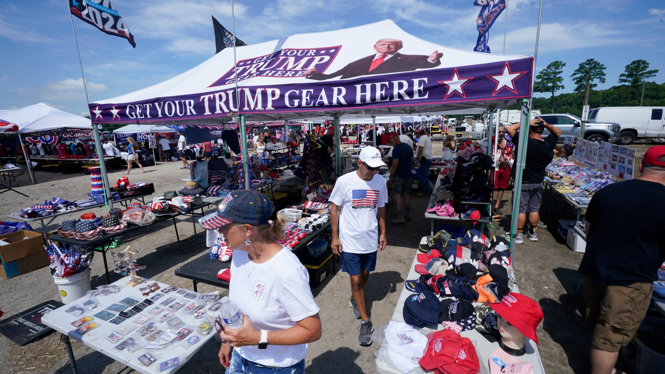 People arrive ahead of a campaign rally for Republican presidential candidate former President Donald Trump in Chesapeake, Va., Friday June 28, 2024. (AP Photo/Steve Helber)