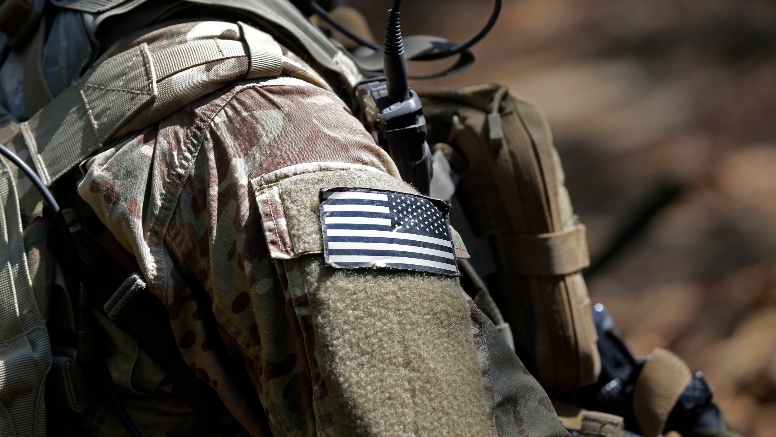 FILE - A U.S. flag patch adorns the uniform of a paratrooper, April 21, 2017, during a training exercise at Fort Bragg, N.C. Fifteen current or retired Joint Base Lewis-McChord servicemen who say the Army failed to protect them from a military doctor who's been charged with sexual abuse are seeking $5 million in damages for the emotional distress they say they've suffered. (AP Photo/Gerry Broome, File)
