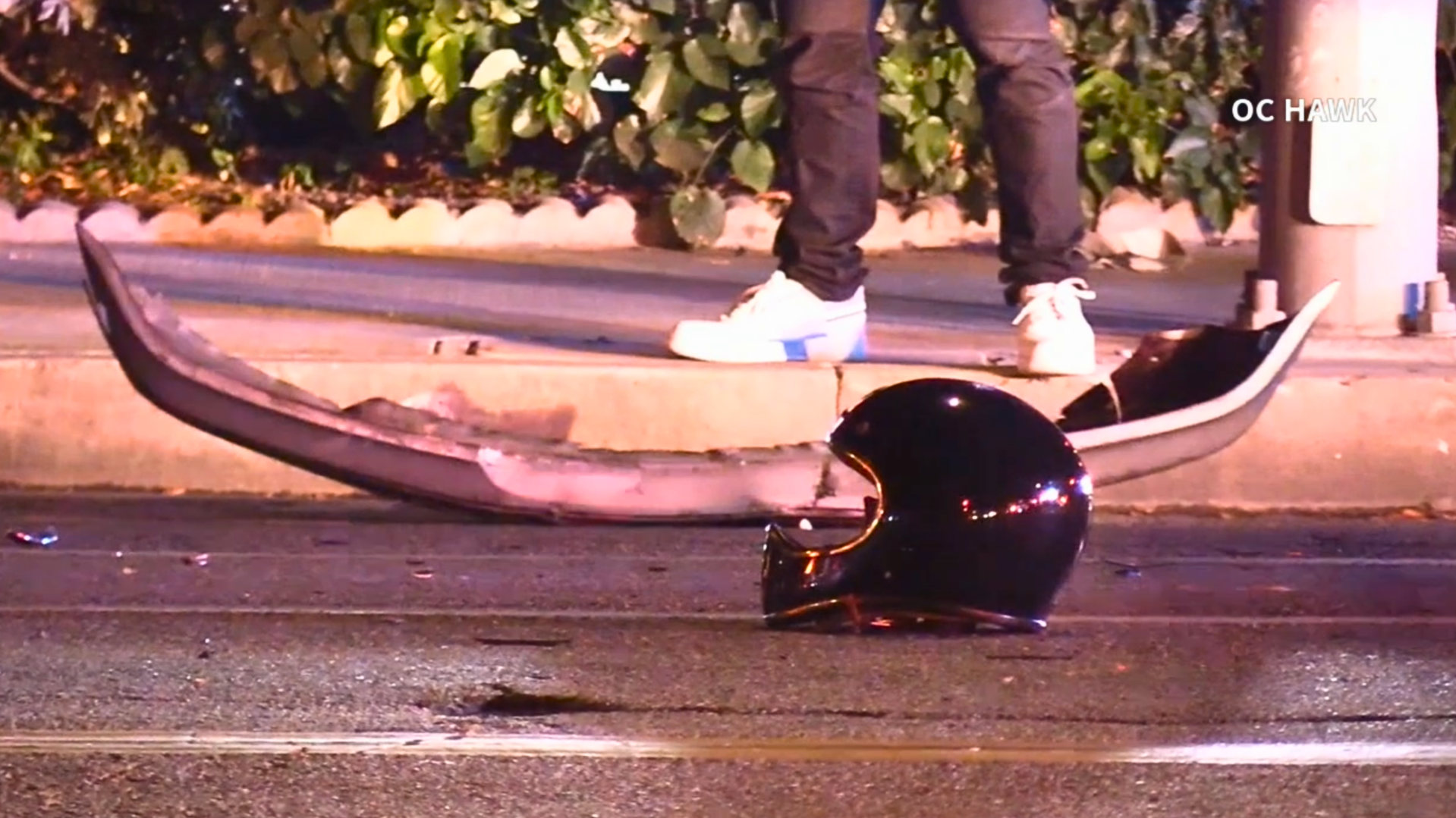 The victim's motorcycle helmet is seen on the street after the rider was killed in a crash with a suspected DUI driver in Fullerton on June 12, 2024. (OC Hawk)