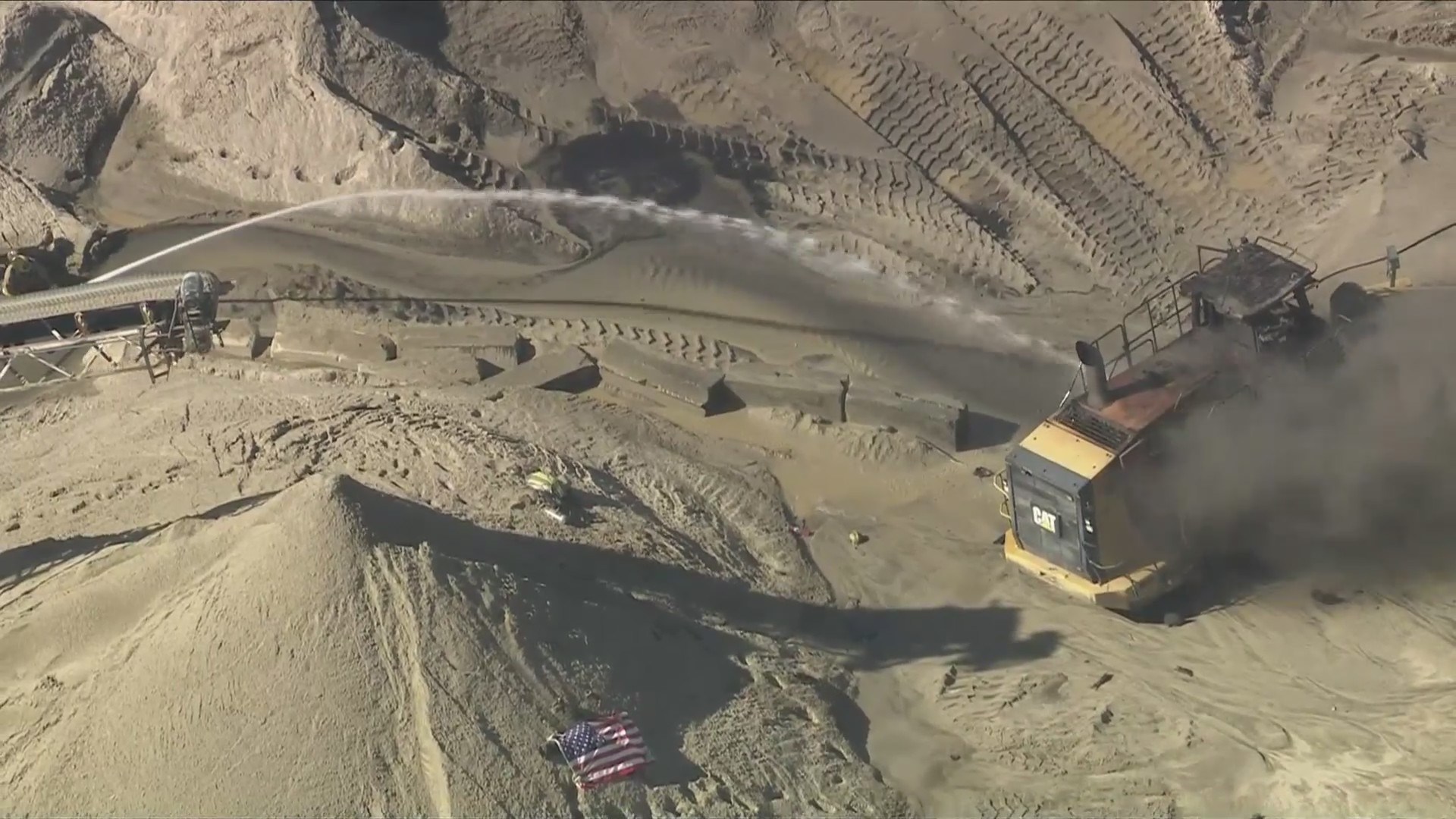 Firefighters work to extinguish the burning tractor vehicle after a ddeadly explosion near Palmdale on June 14, 2024. (KTLA)