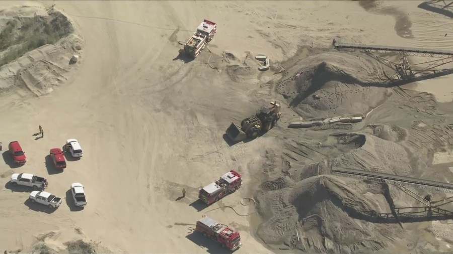 Firefighters work to extinguish the burning tractor vehicle after a ddeadly explosion near Palmdale on June 14, 2024. (KTLA)