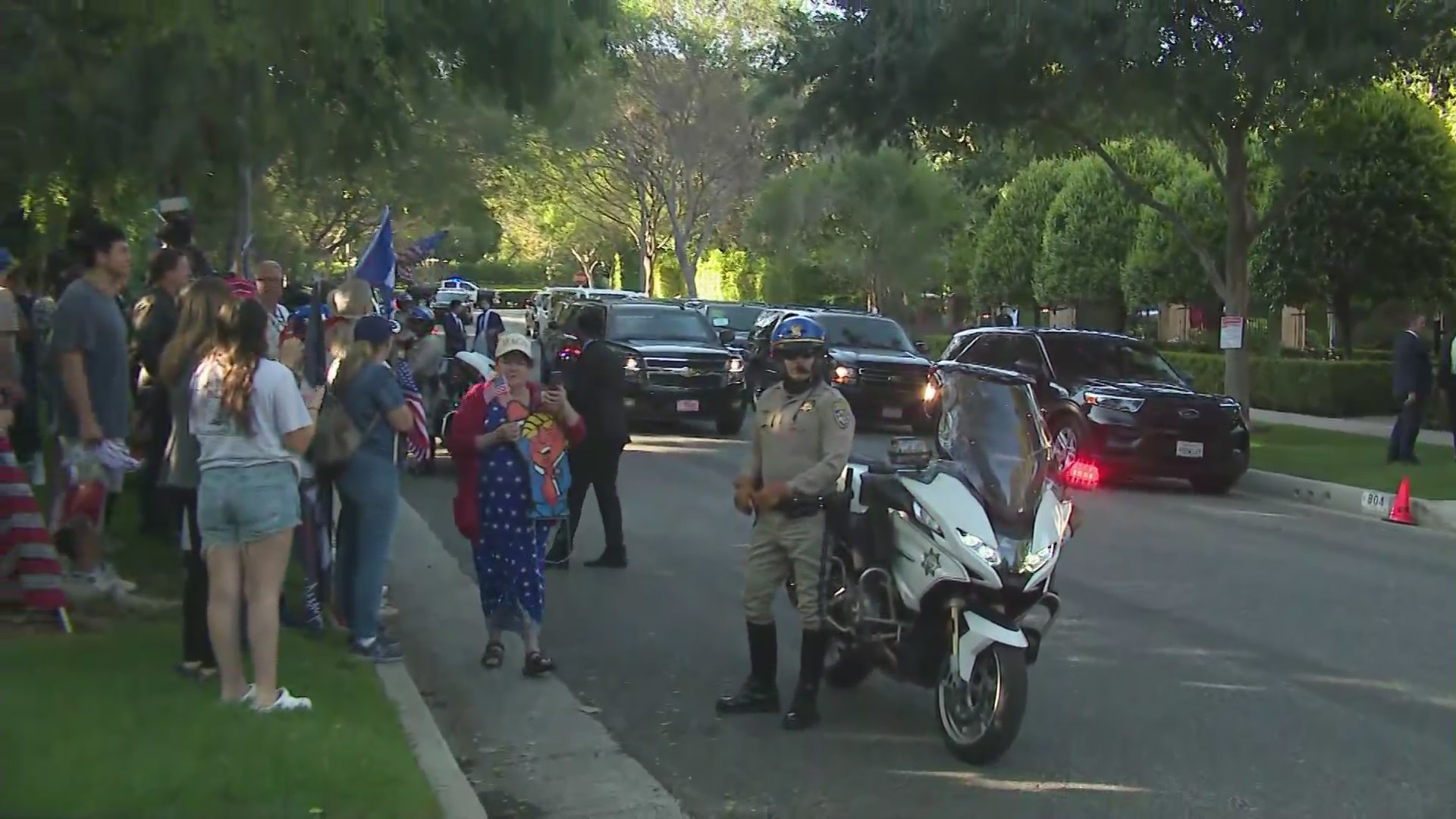 Supporters waiting outside as Donald Trump's motorcade arrives at a Beverly Hills home for a campaign fundrasiing event on June, 7, 2024. (KTLA)