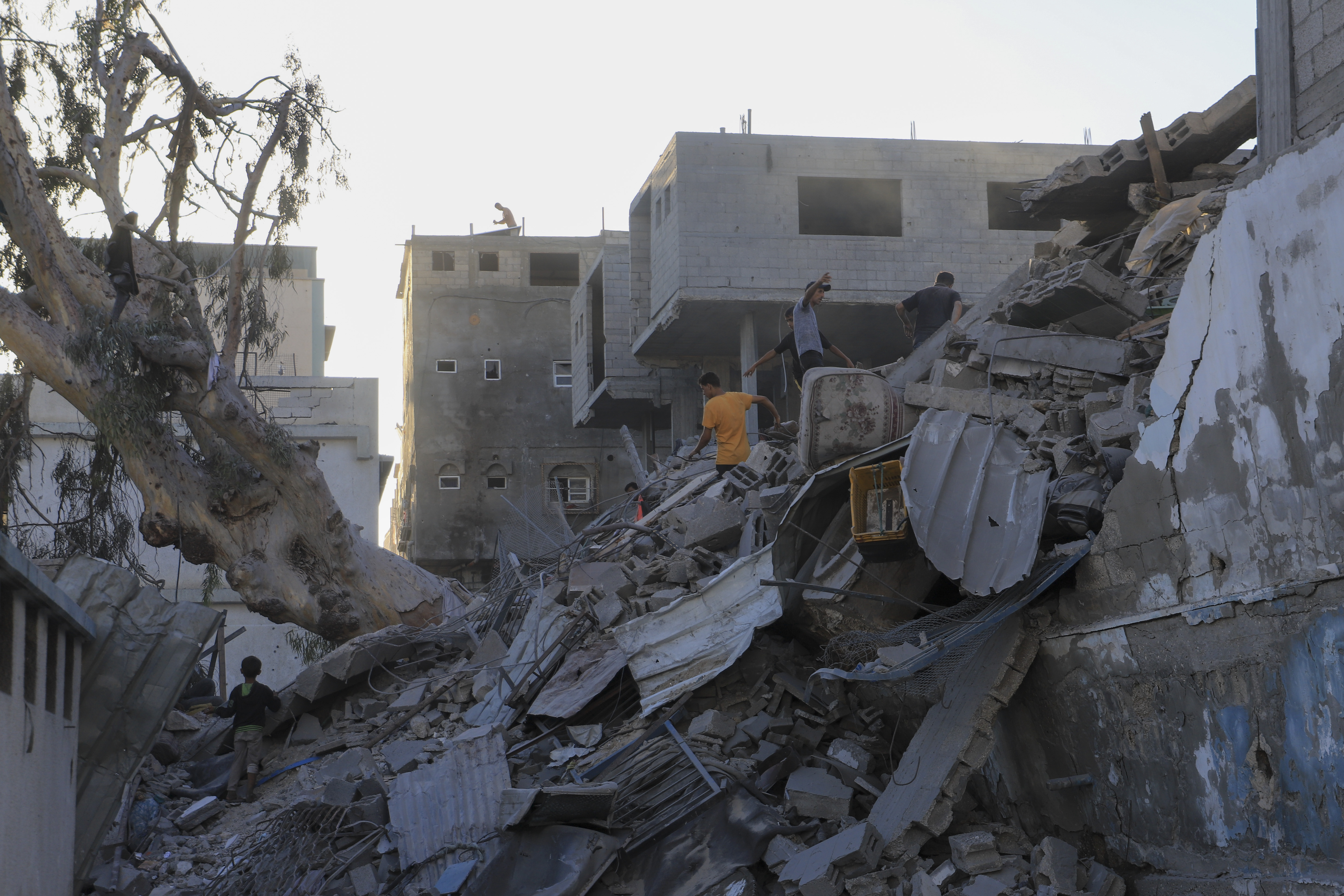 Palestinians search for bodies and survivors in the rubble of a residential building destroyed in an Israeli airstrike in Khan Younis, Gaza Strip, Wednesday, July 3, 2024. (AP Photo /Jehad Alshrafi)