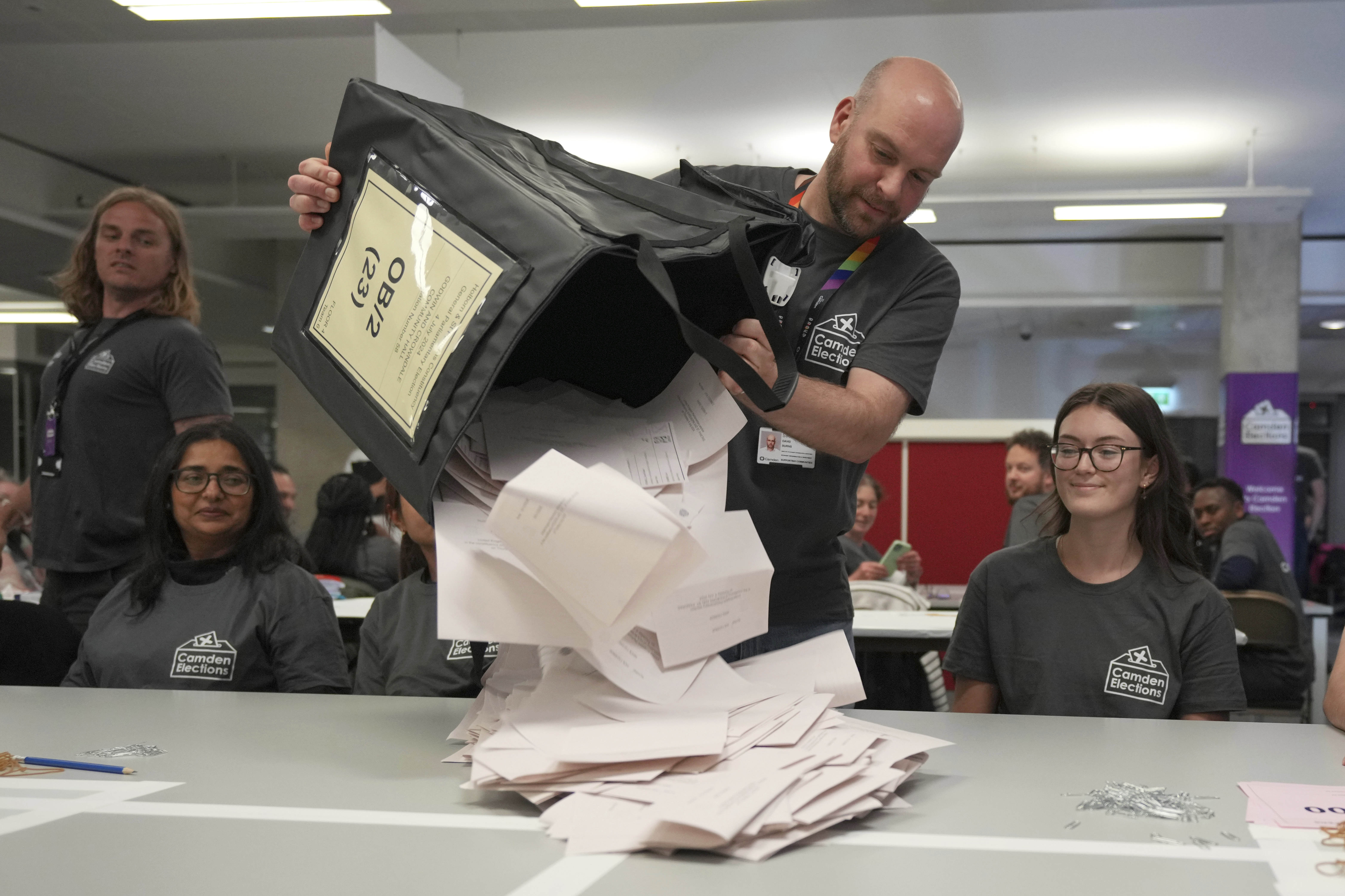 Boxes of votes are emptied ready to be counted for the British Parliamentary constituency of Holborn and St Pancras where the Labour Party leader Keir Starmer is standing for election, in London, Thursday, July 4, 2024. Britain's Labour Party appears to be headed for a huge majority in the 2024 UK election, an exit poll suggested. The poll released moments after voting closed indicated that Labour leader Keir Starmer will be the country's next prime minister. (AP Photo/Kin Cheung)