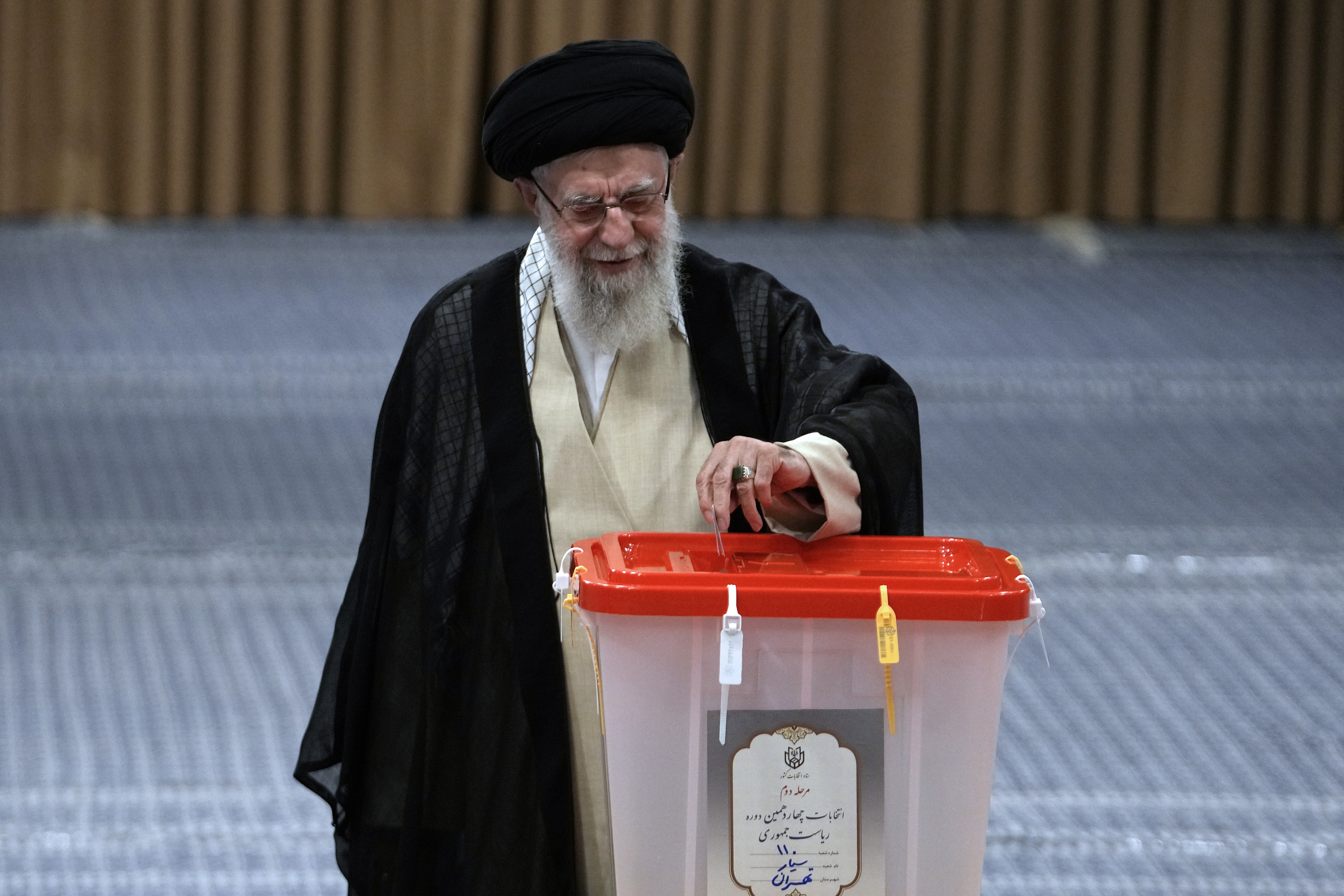 Iranian Supreme Leader Ayatollah Ali Khamenei casts his vote for the presidential runoff election in Tehran, Iran, Friday, July 5, 2024. (AP Photo/Vahid Salemi)