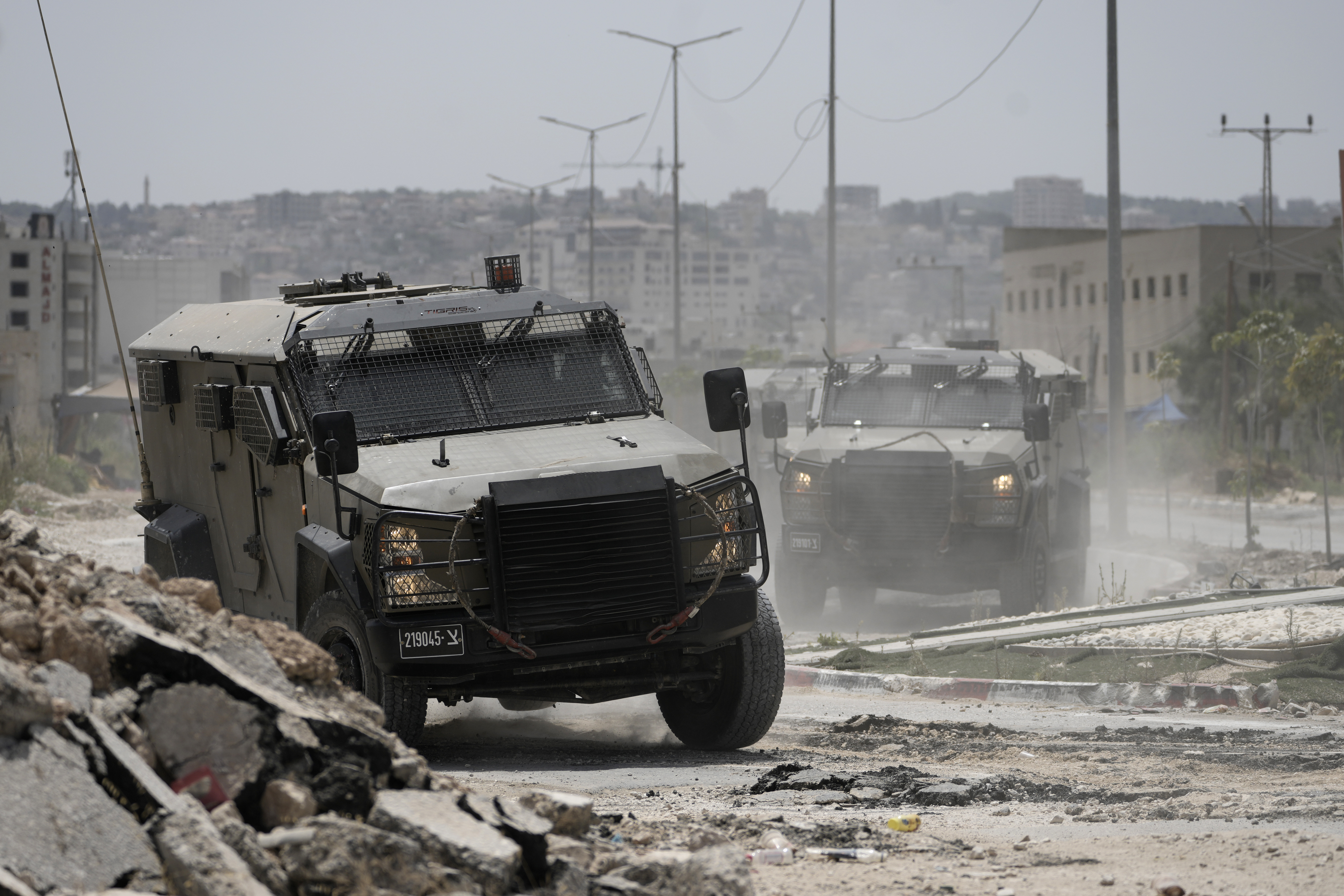Israeli military vehicles maneuver during an operation in the West Bank city of Jenin, Friday, July 5, 2024. The Israeli military said Friday it was conducting counterterrorism activity that included an airstrike in the area of the West Bank city of Jenin. Palestinian authorities said five people were killed. (AP Photo/Majdi Mohammed)