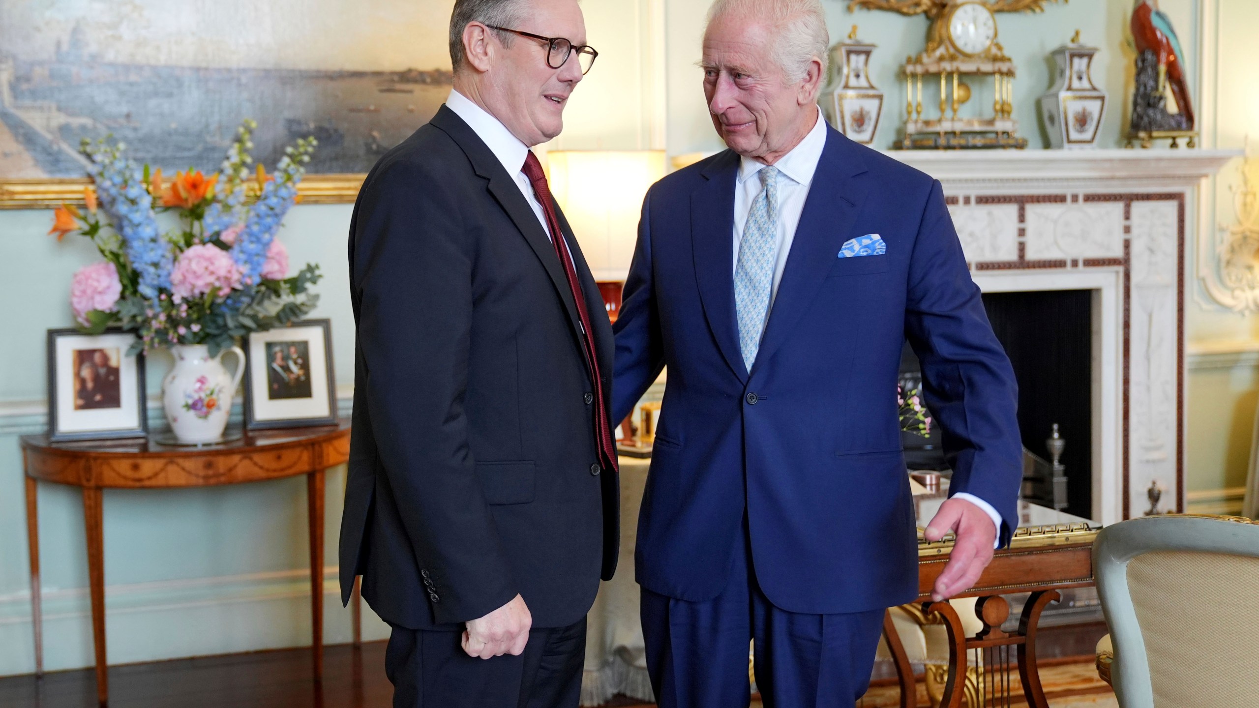 Britain's King Charles III, right, speaks with Keir Starmer where he invited the Labour Party leader to become prime minister and to form a new government, following the landslide general election victory for the Labour Party, in London, Friday, July 5, 2024. (Yui Mok, Pool Photo via AP)