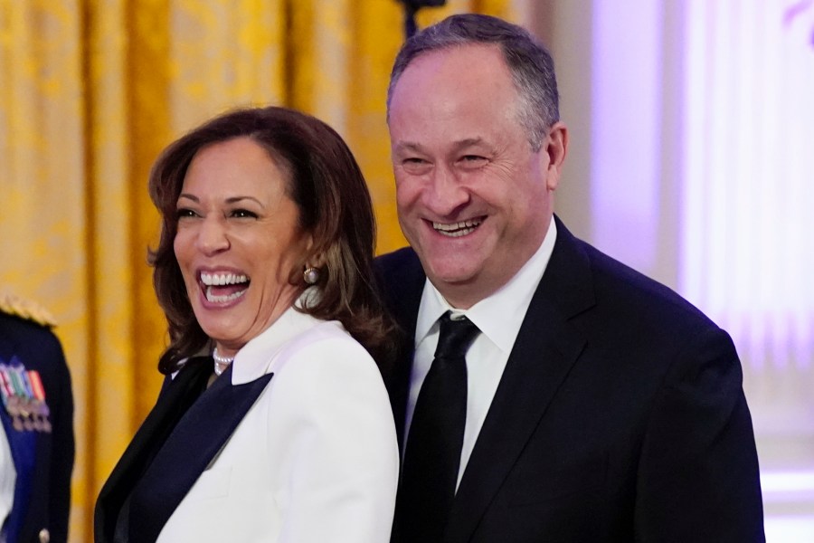 FILE - Vice President Kamala Harris, left, and second gentleman Doug Emhoff arrive in the East Room of the White House, Feb. 11, 2023, in Washington. Emhoff has tested positive for COVID-19 after experiencing mild symptoms, his office announced Sunday, July 7, 2024, but Harris, has tested negative and remains asymptomatic. (AP Photo/Manuel Balce Ceneta, File)